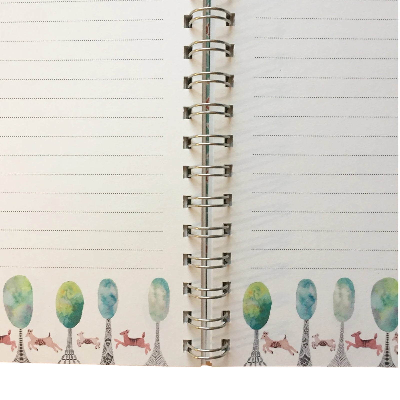 Notebook with decorative pages featuring trees and deers on a white background.