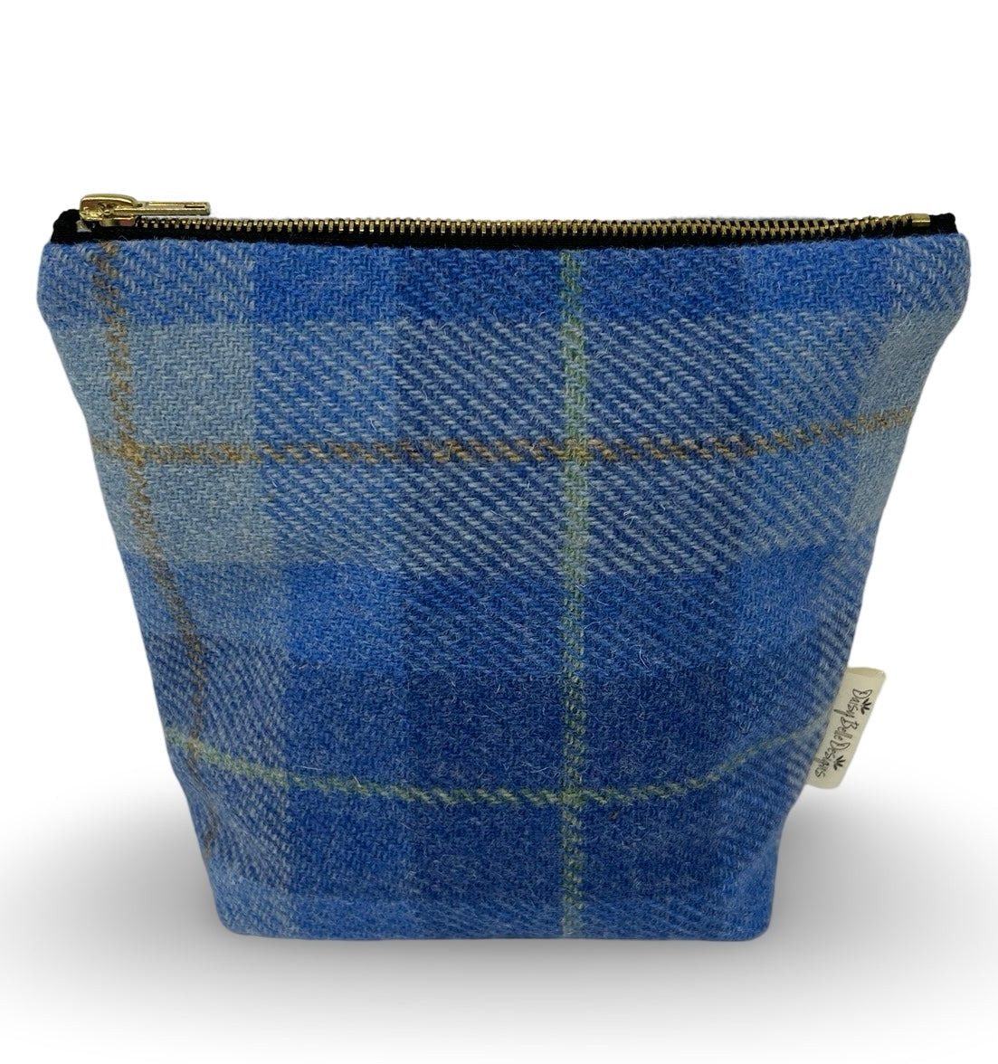 harris tweed wash bag in pale blue check with a gold coloured zip.