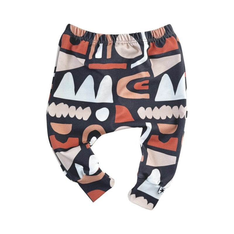 A pair of multicolored baby harem leggings with a pattern of abstract shapes.