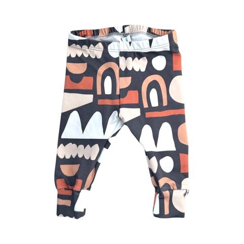 A pair of multicolored baby harem leggings with a pattern of abstract shapes.