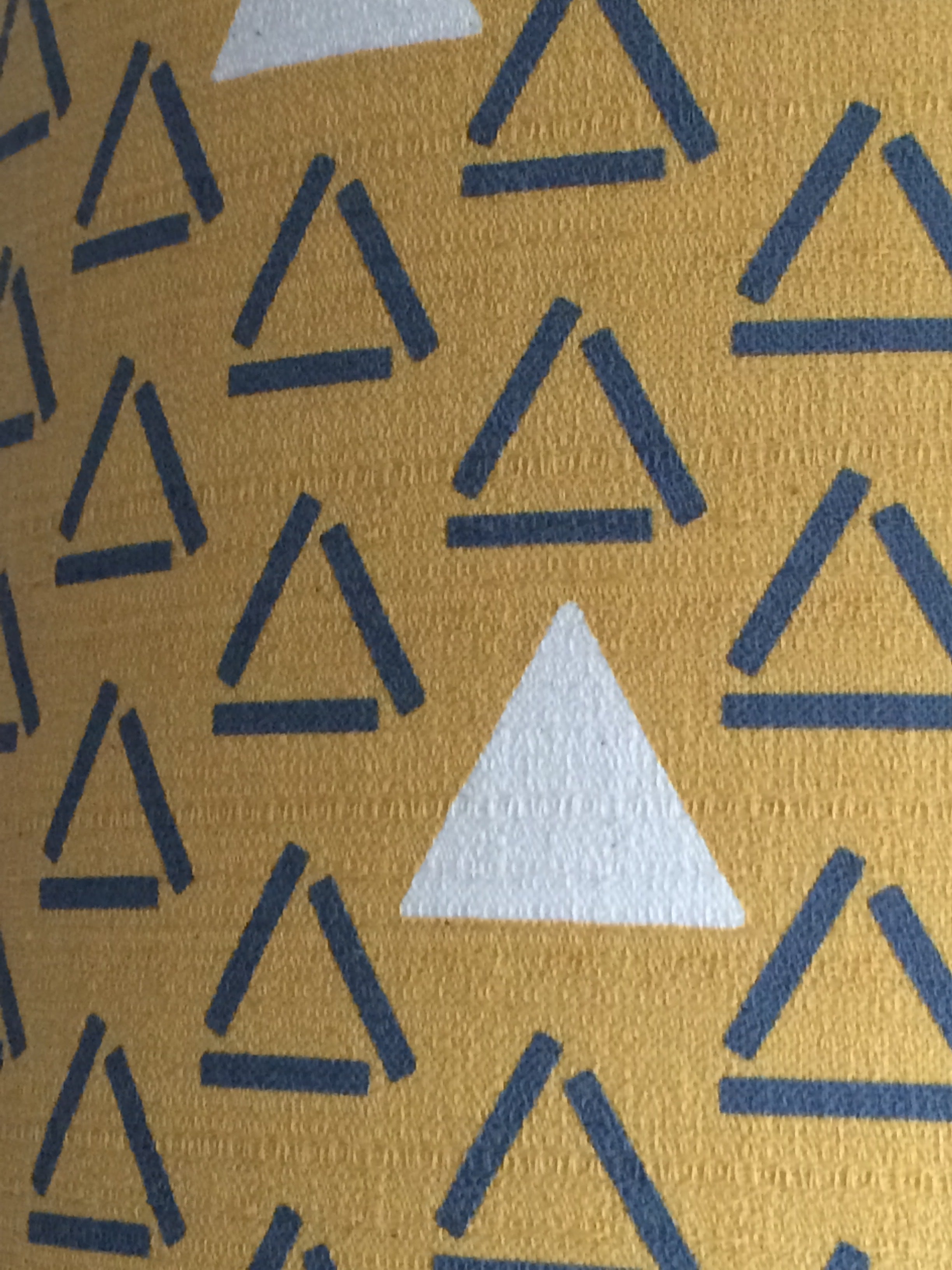 mustard barkcloth fabric with grey open triangles and white closed and filled triangles