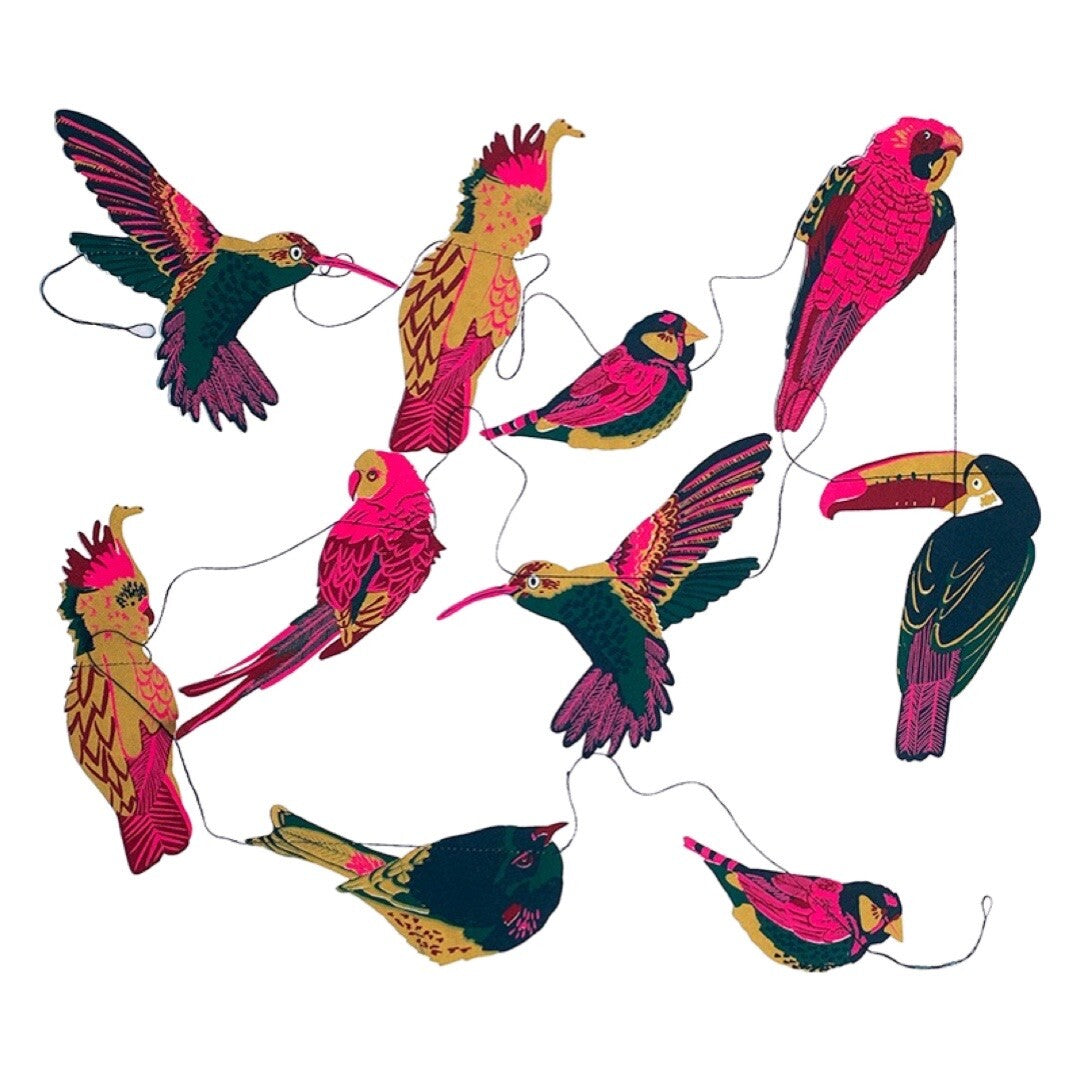 A tropical bird garland featuring ten screen-printed paper toucans, parrots and hummingbirds in bright pink, green and mustard.