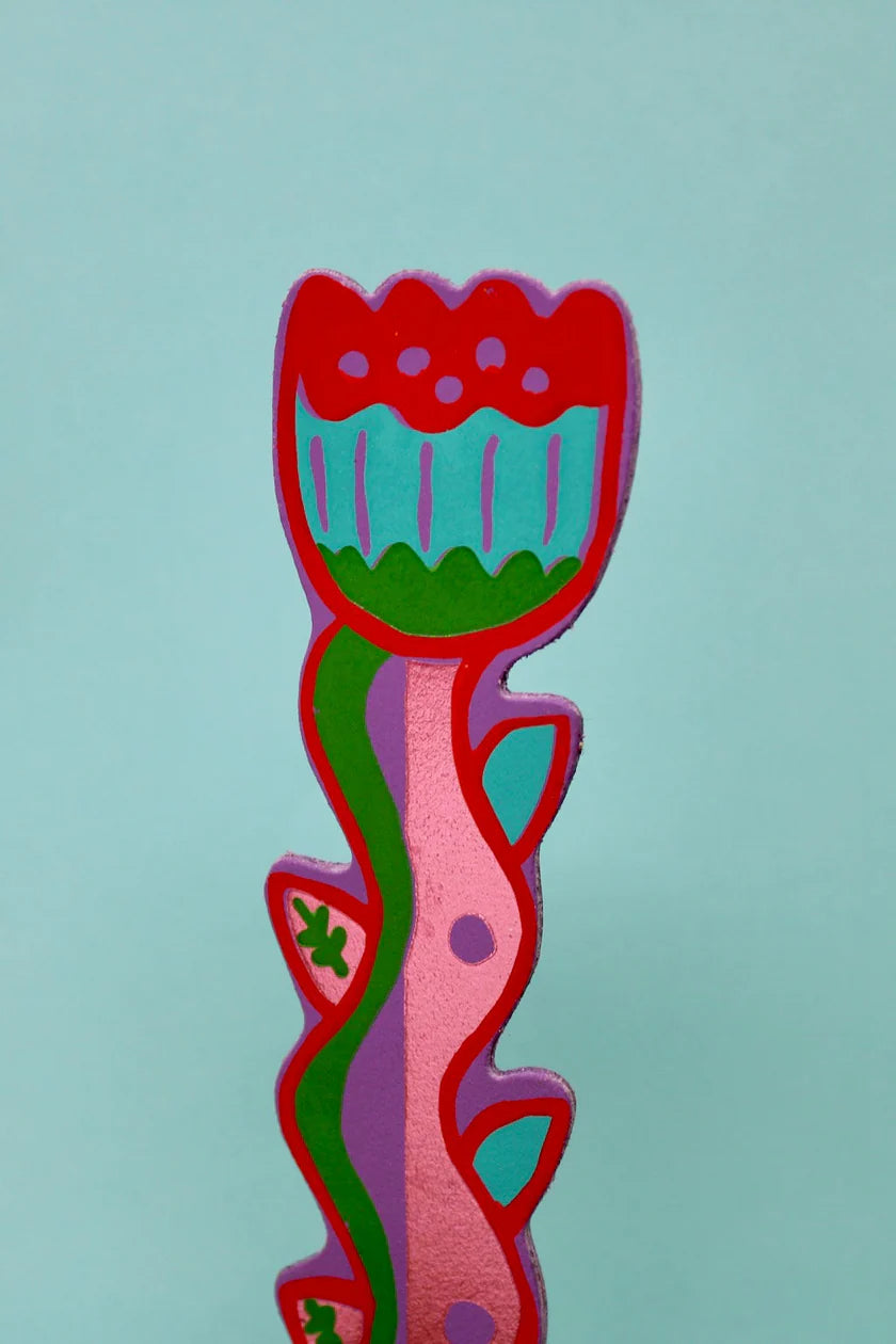 Colourful flower bookmark on a light blue background.