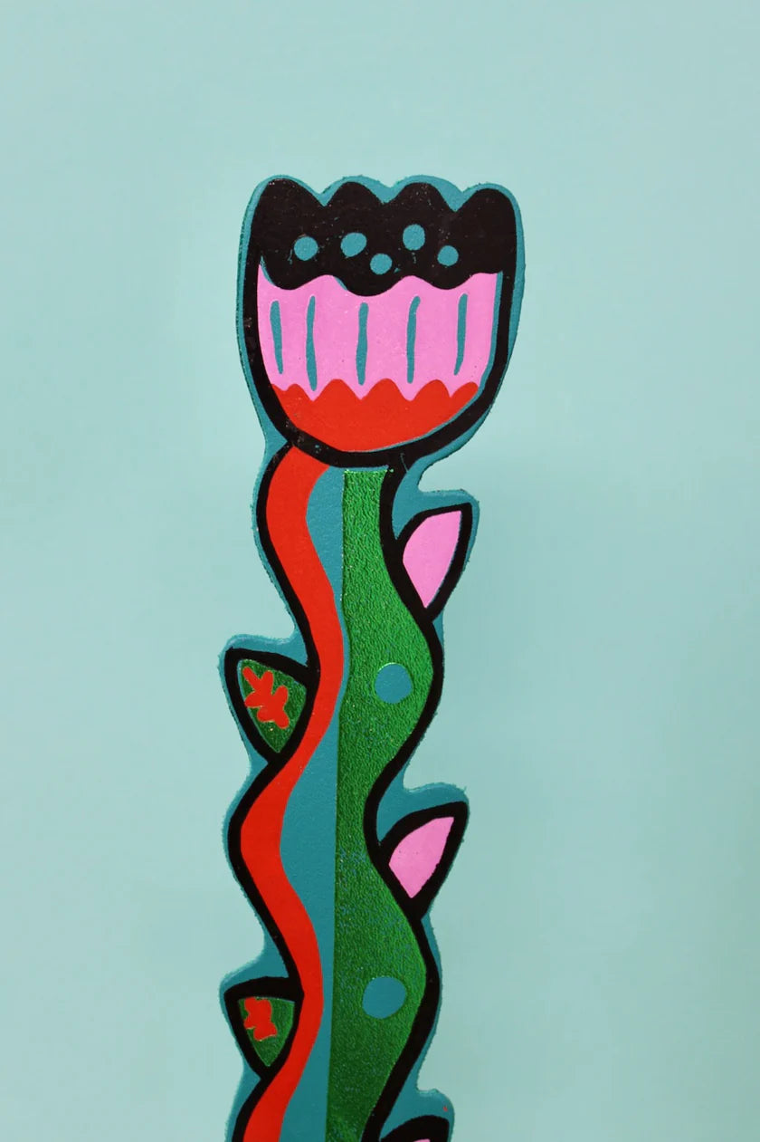 Colourful flower bookmark on a light blue background.