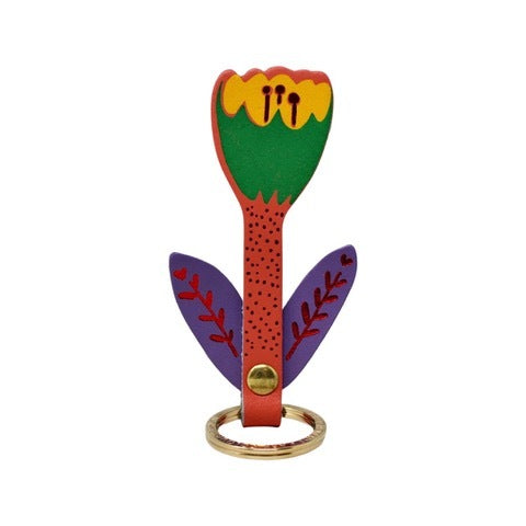 A tulip-shaped leather keyring with a pink and yellow flower. a coral stem and purple leaves with red detail on a gold-plated ring.