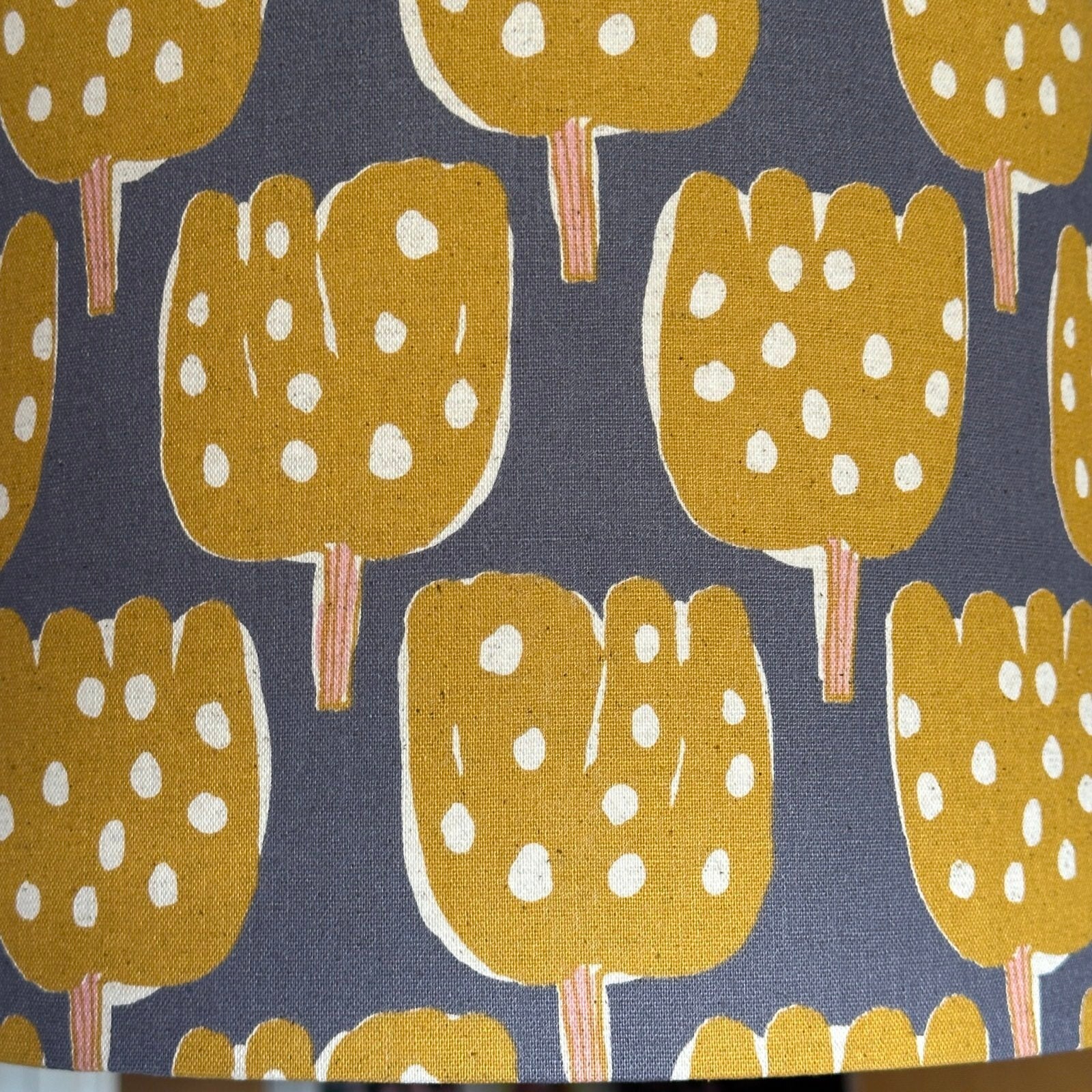 Grey canvas fabric with mustard tulip-shaped trees with pale pink tree trunks