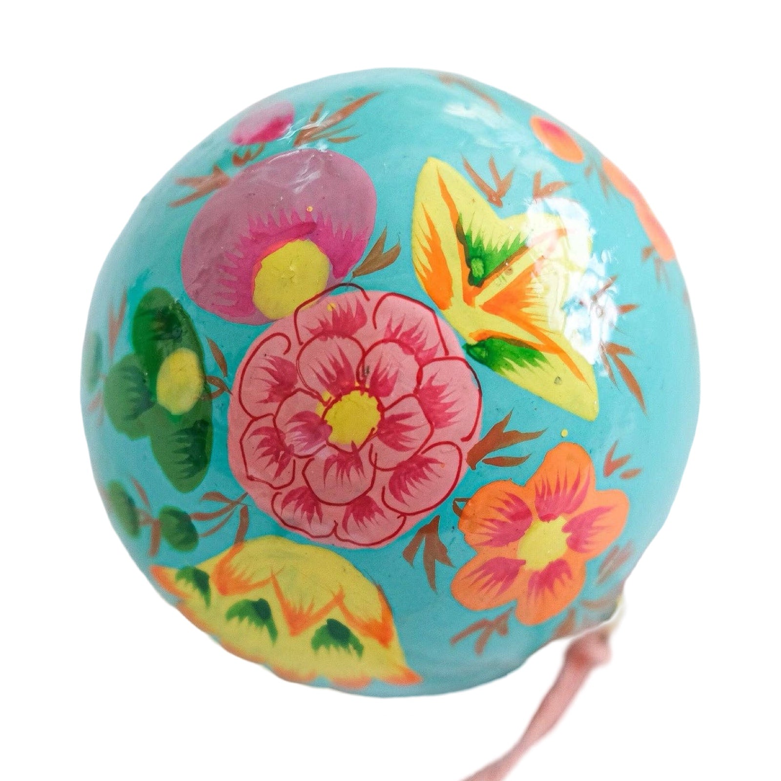 A round papier mache bauble in turquoise with a pink, yellow and green floral design.