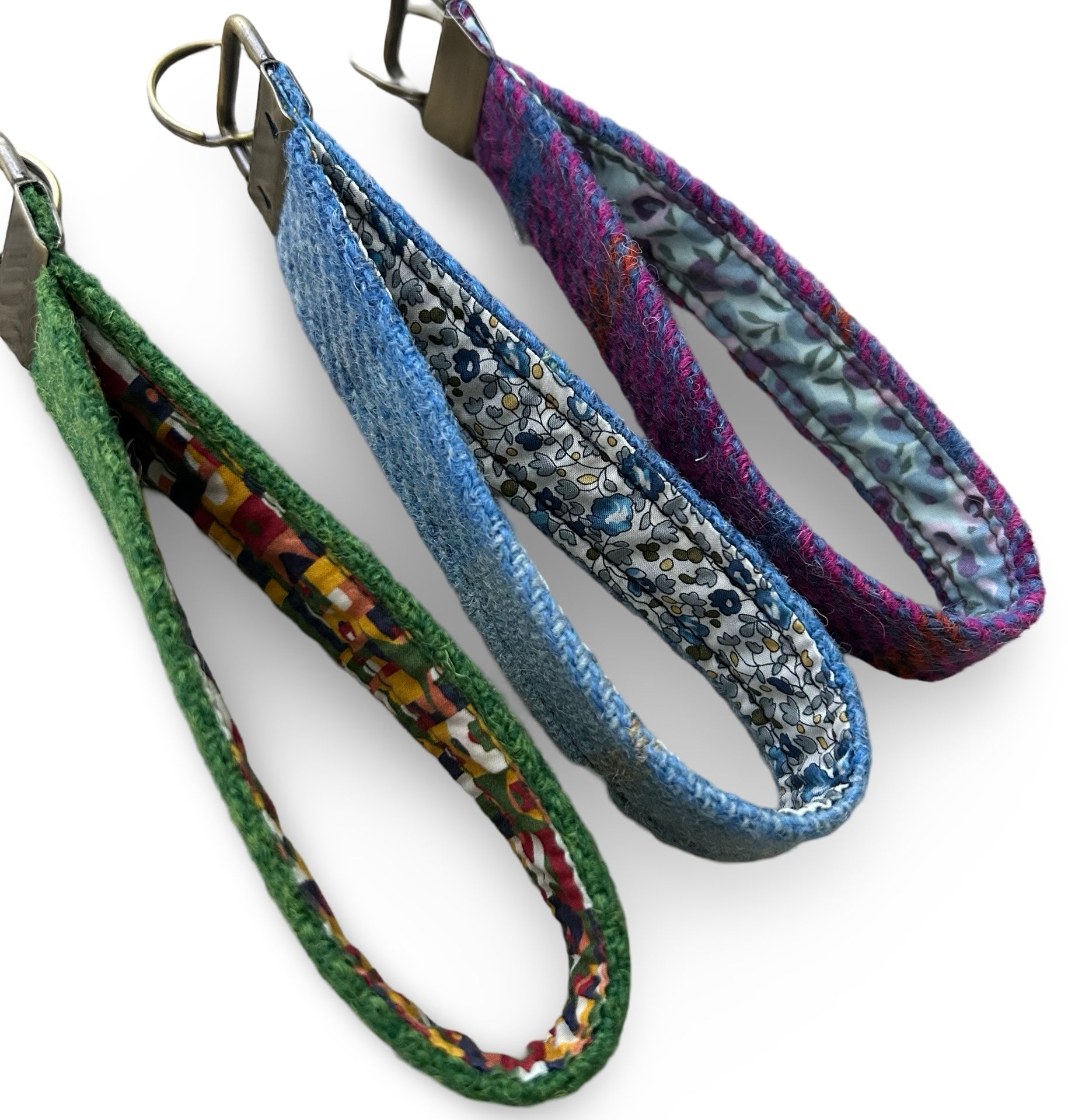 Showing the Liberty print inside of three Harris tweed keyring loops.