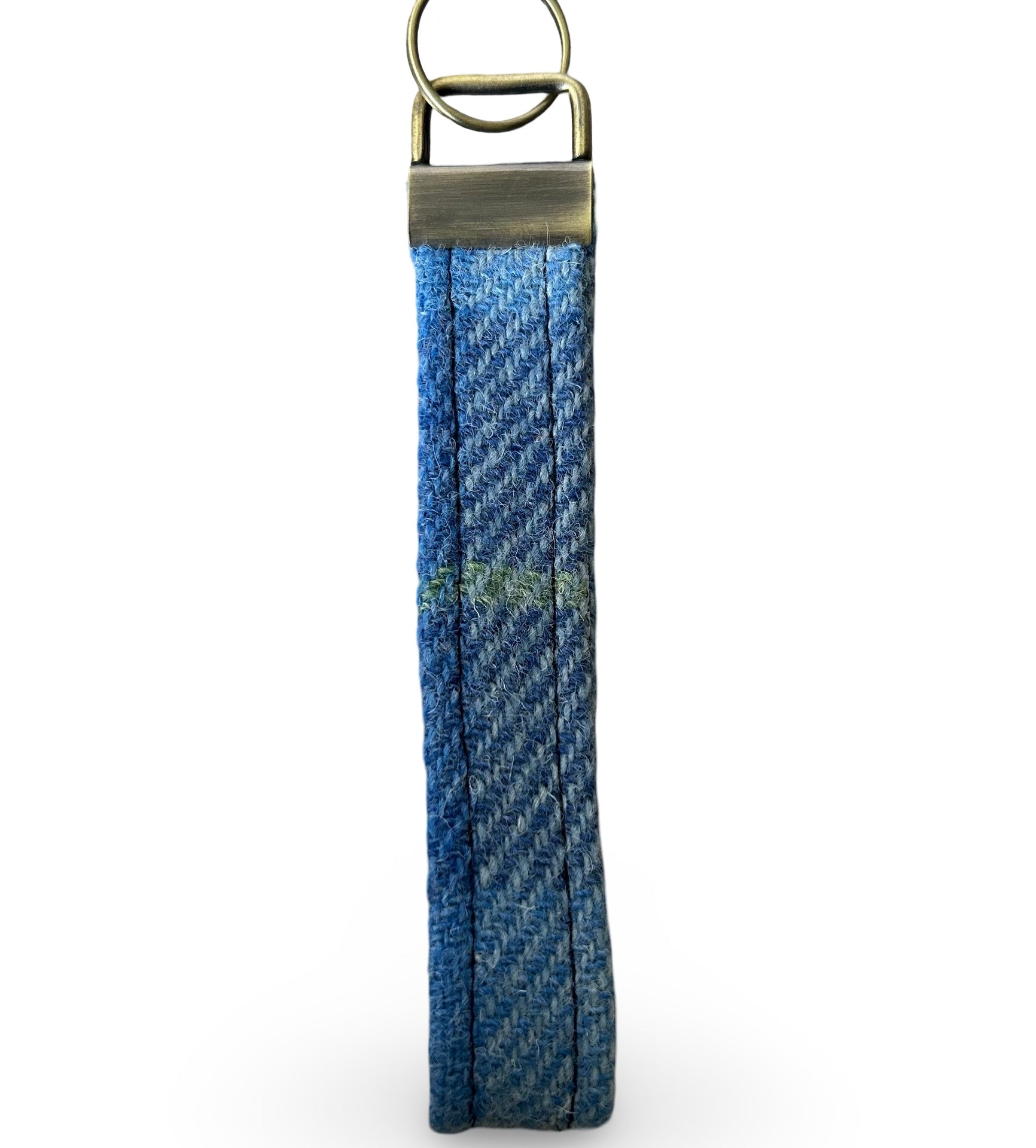 Blue Harris tweed key ring in a long loop design with a metal attachment at the top for connecting keys.