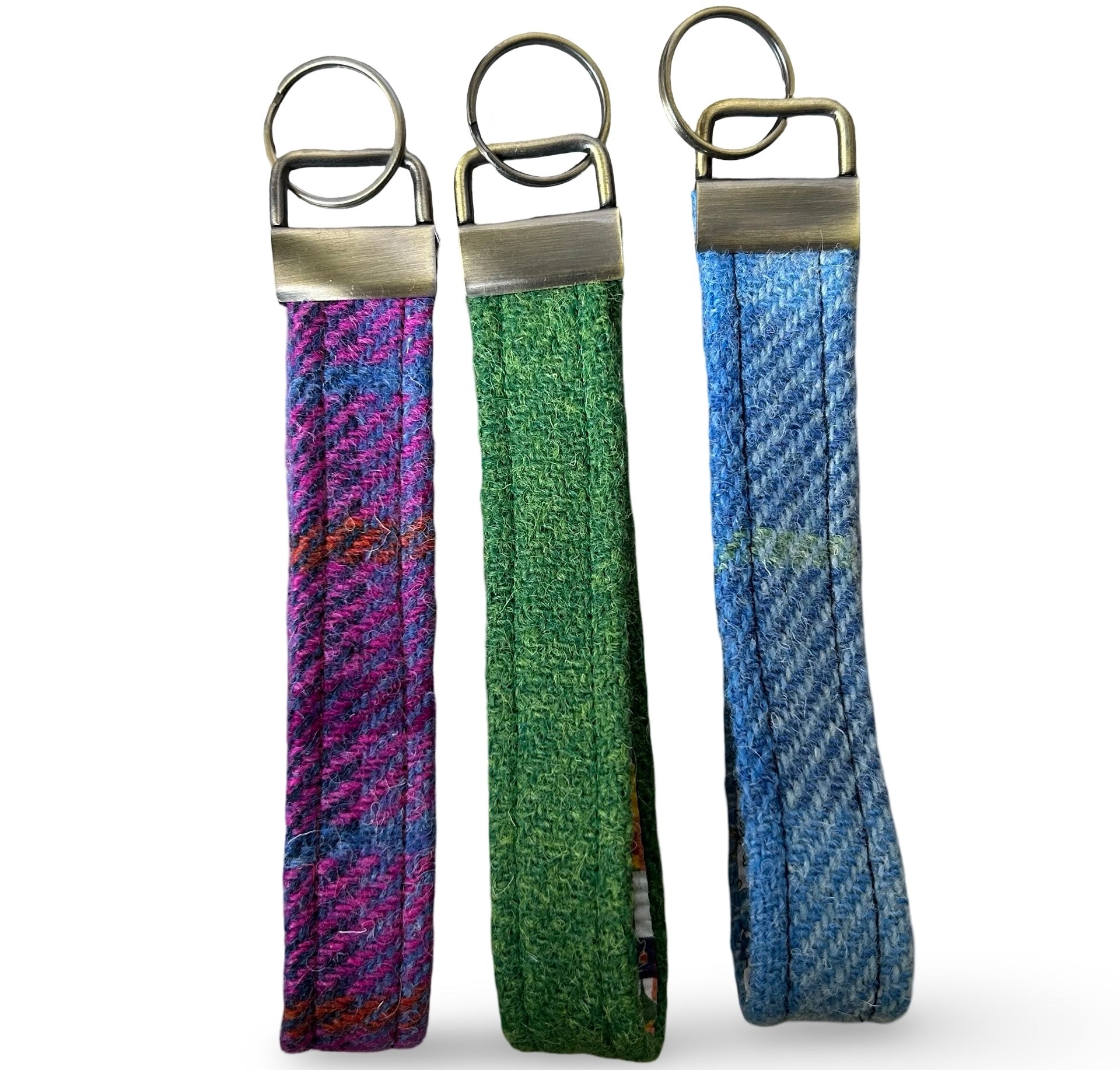 Three tweed wrist loop key rings with metal ring attachment.  One is blue tweed, one purple and one green.