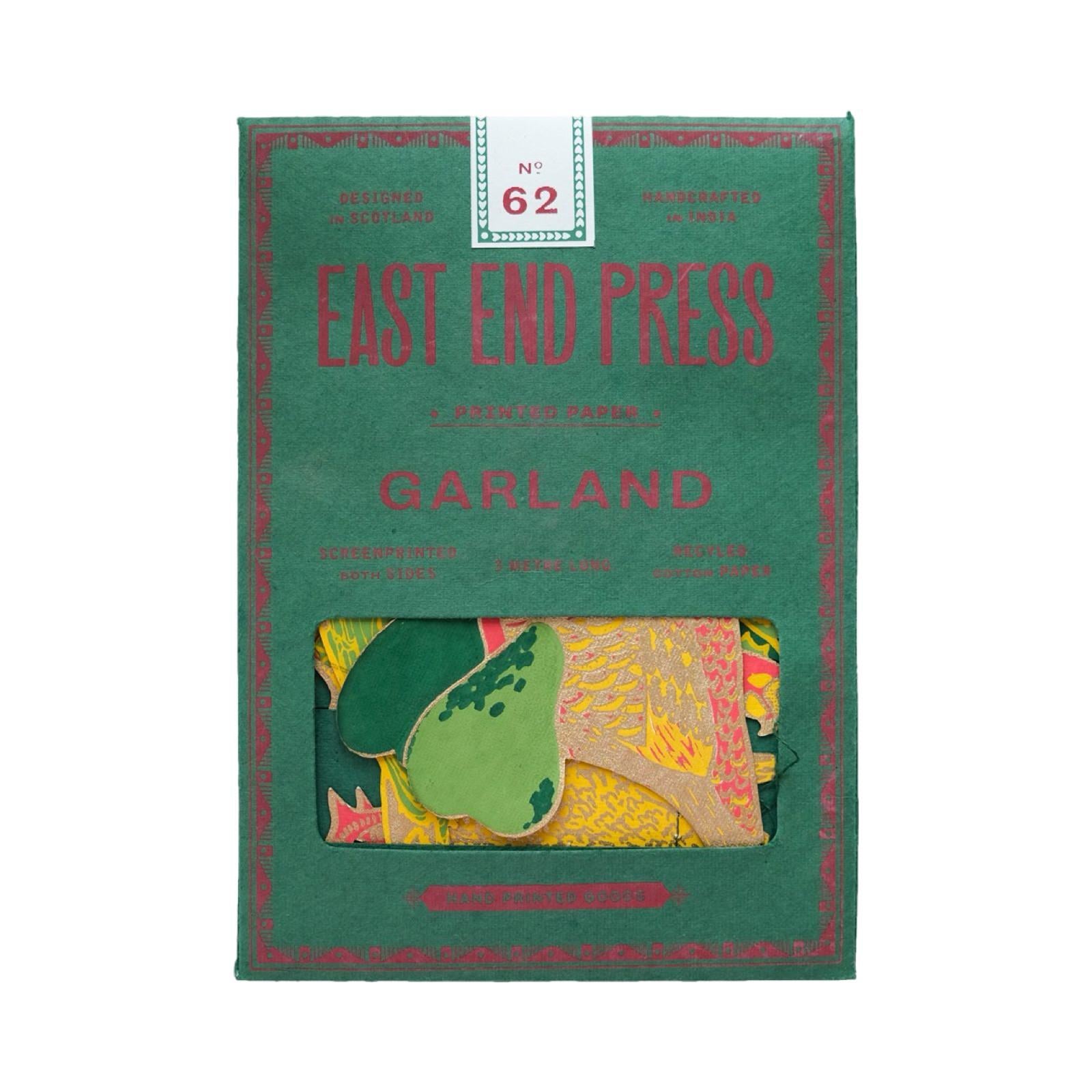 Green packet of 12 days of Christmas paper garland, featuring twelve screen-printed characters including a piper, a dancer and a drummer drumming.