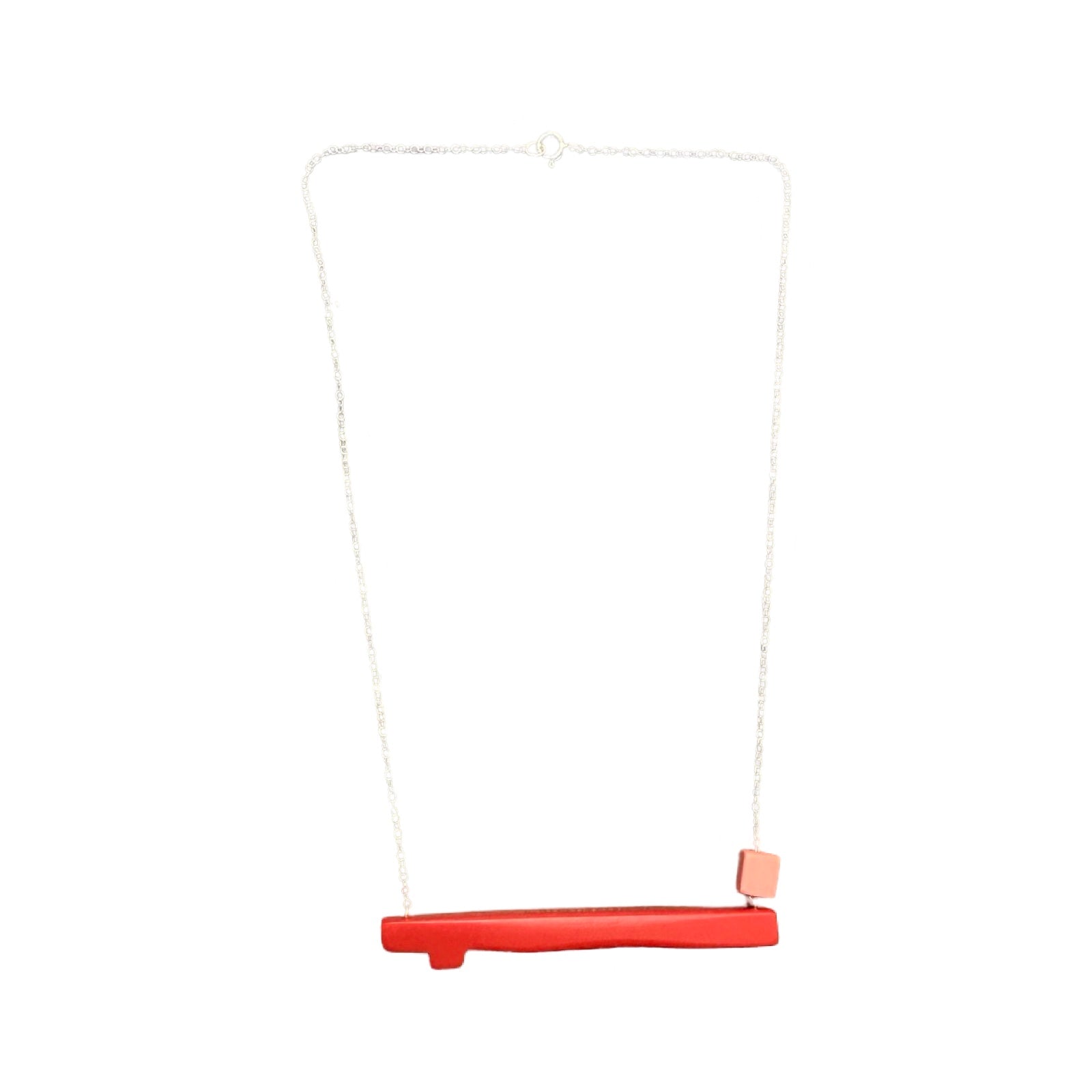 Coral twig shaped necklace with a small pink bead on the right side, hanging from a silver chain.
