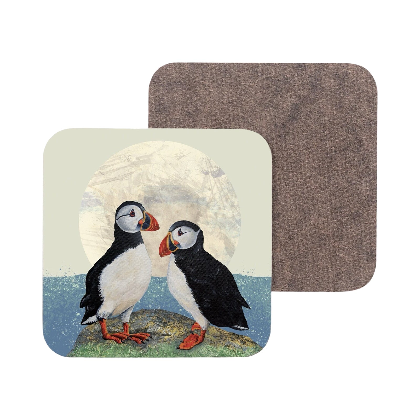 A coaster featuring an illustration of two puffins standing on the edge of a cliff.