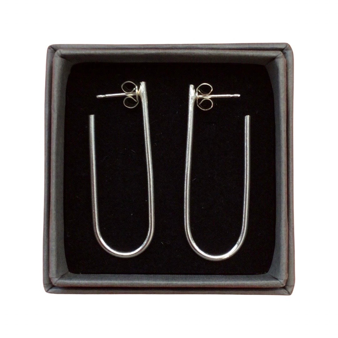 U shaped earrings in silver against a white background.