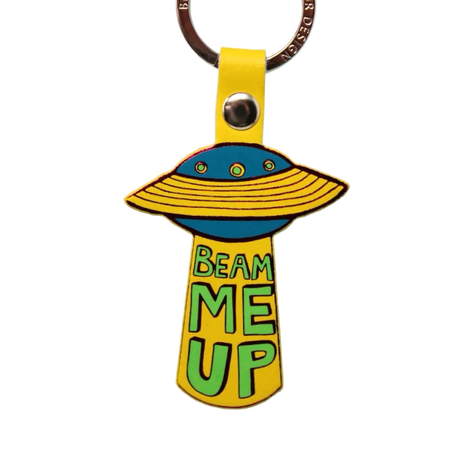 A yellow leather UFO keyring of an teal spaceship with yellow rings and the text 'Beam me up' written underneath in bright green lettering hanging from a gold-plated ring.