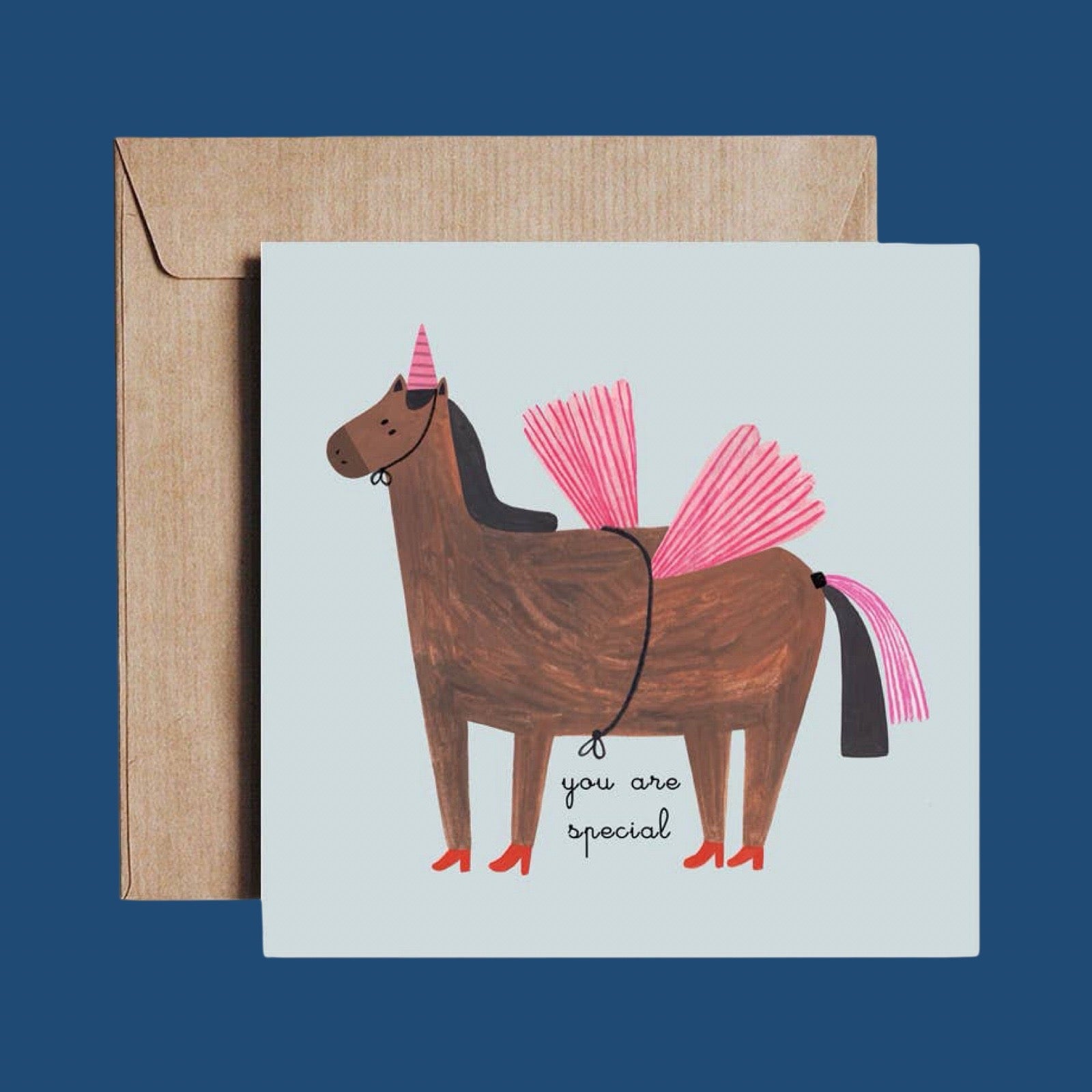 Greeting card with a horse wearing a unicorn costume and 'you are special' text, with a brown envelope, on a blue background.