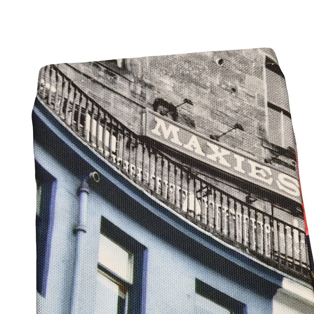 A close up of a tea towel with a print of Victoria Street Edinburgh on it.