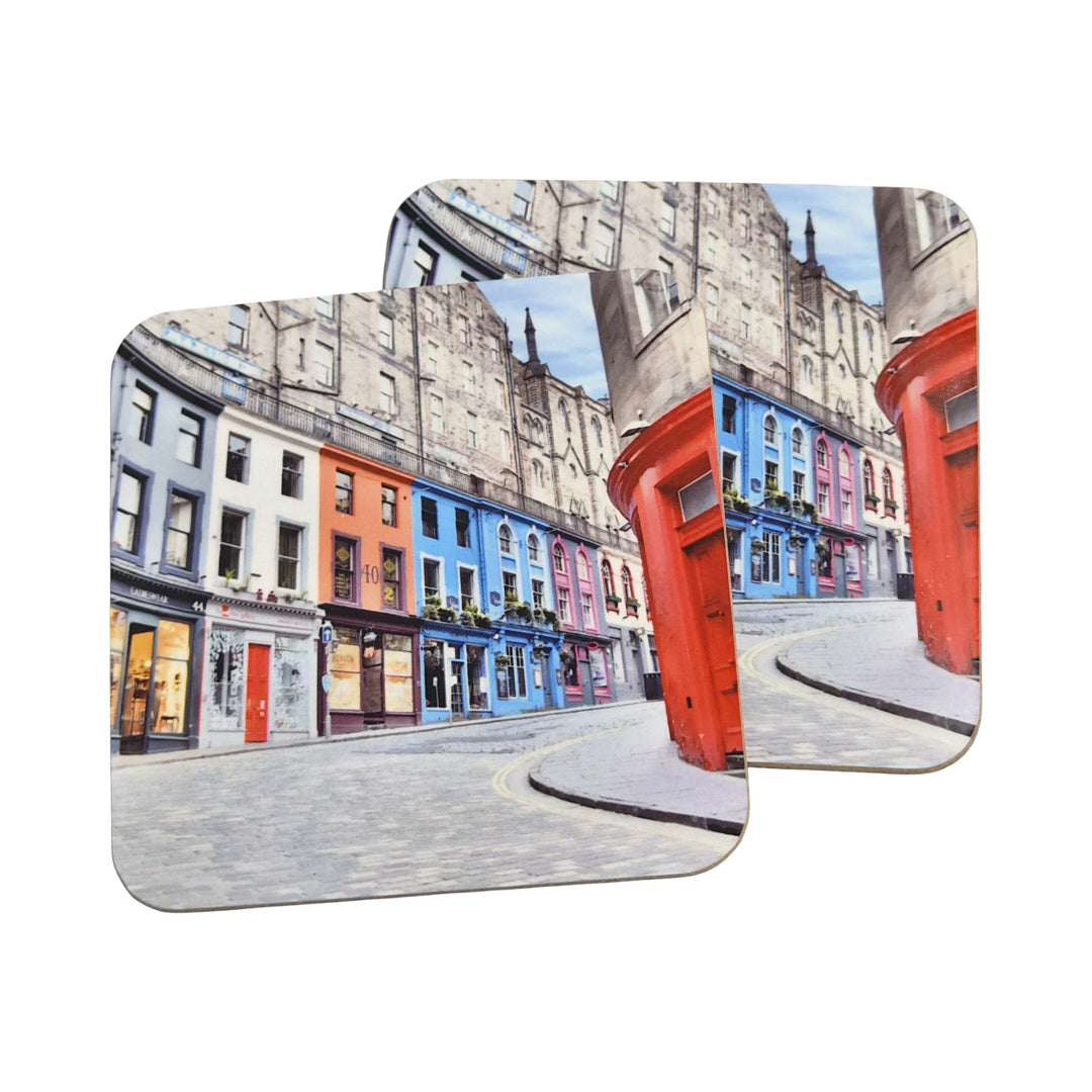 Two coasters with a colorful street scene design on a white background