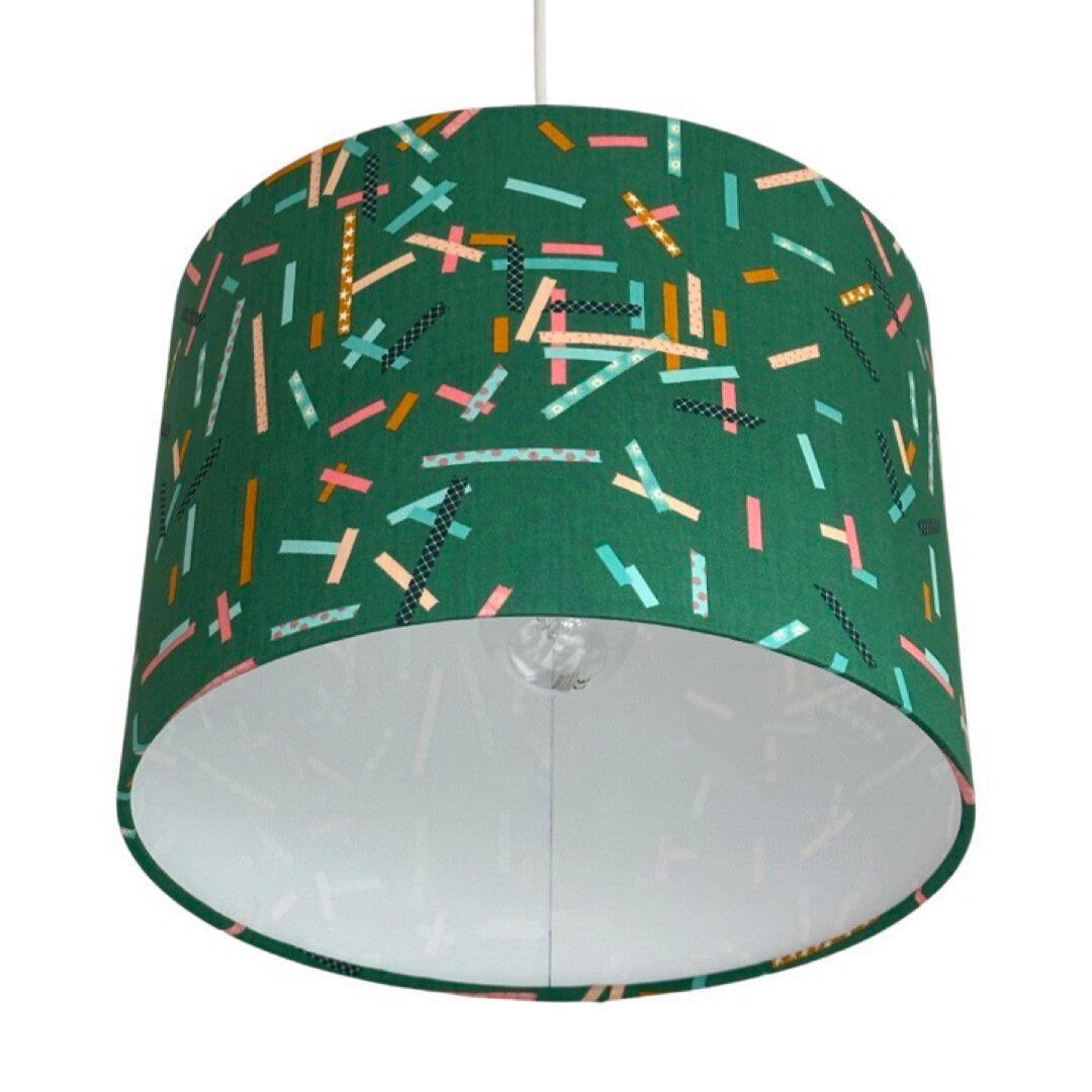 drum lampshade covered in green cotton fabric with coloured strips