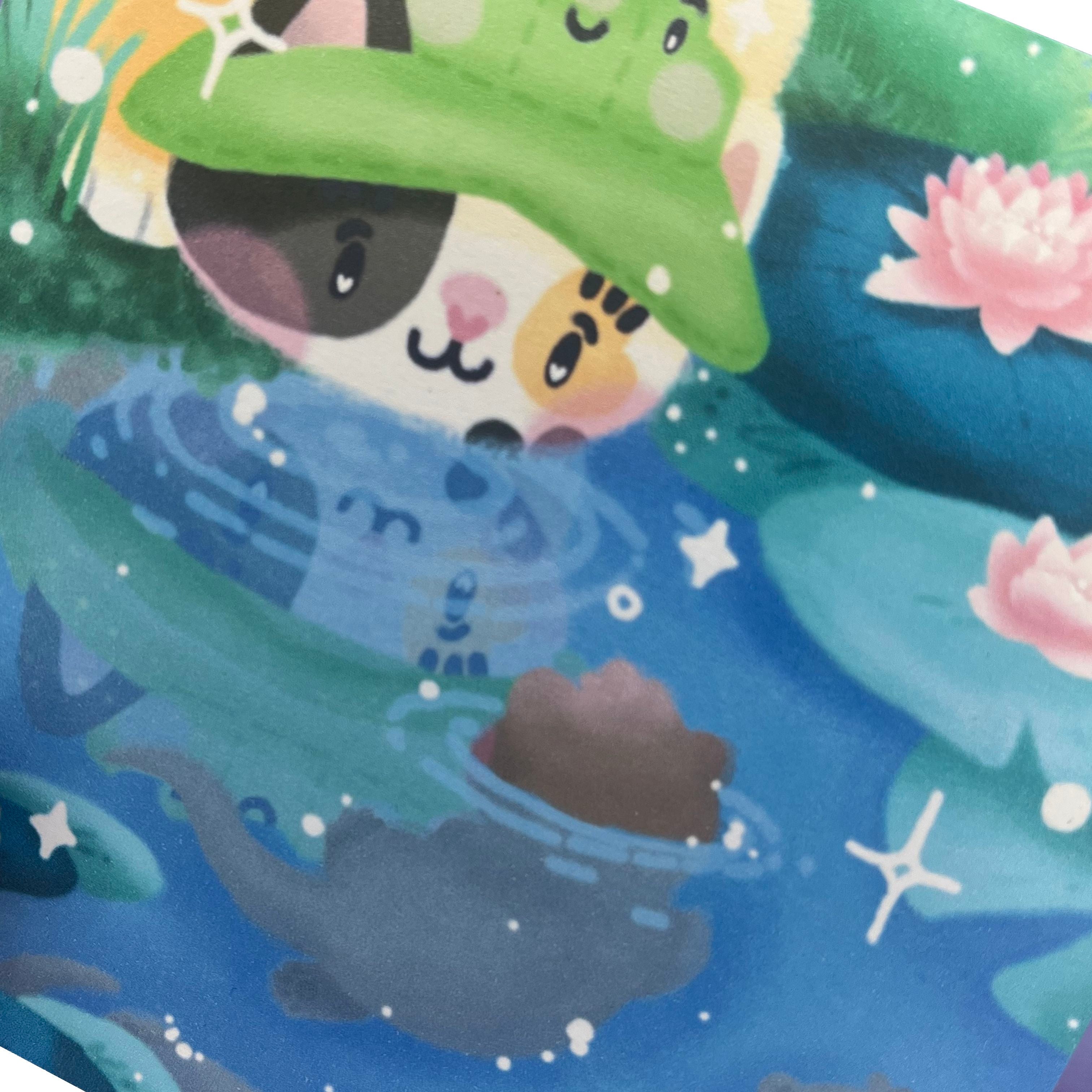 Illustrated print of a calico cat wearing a frog bucket hat, at a waterlily pond with some baby otters. Includes white sparkle-shaped details.