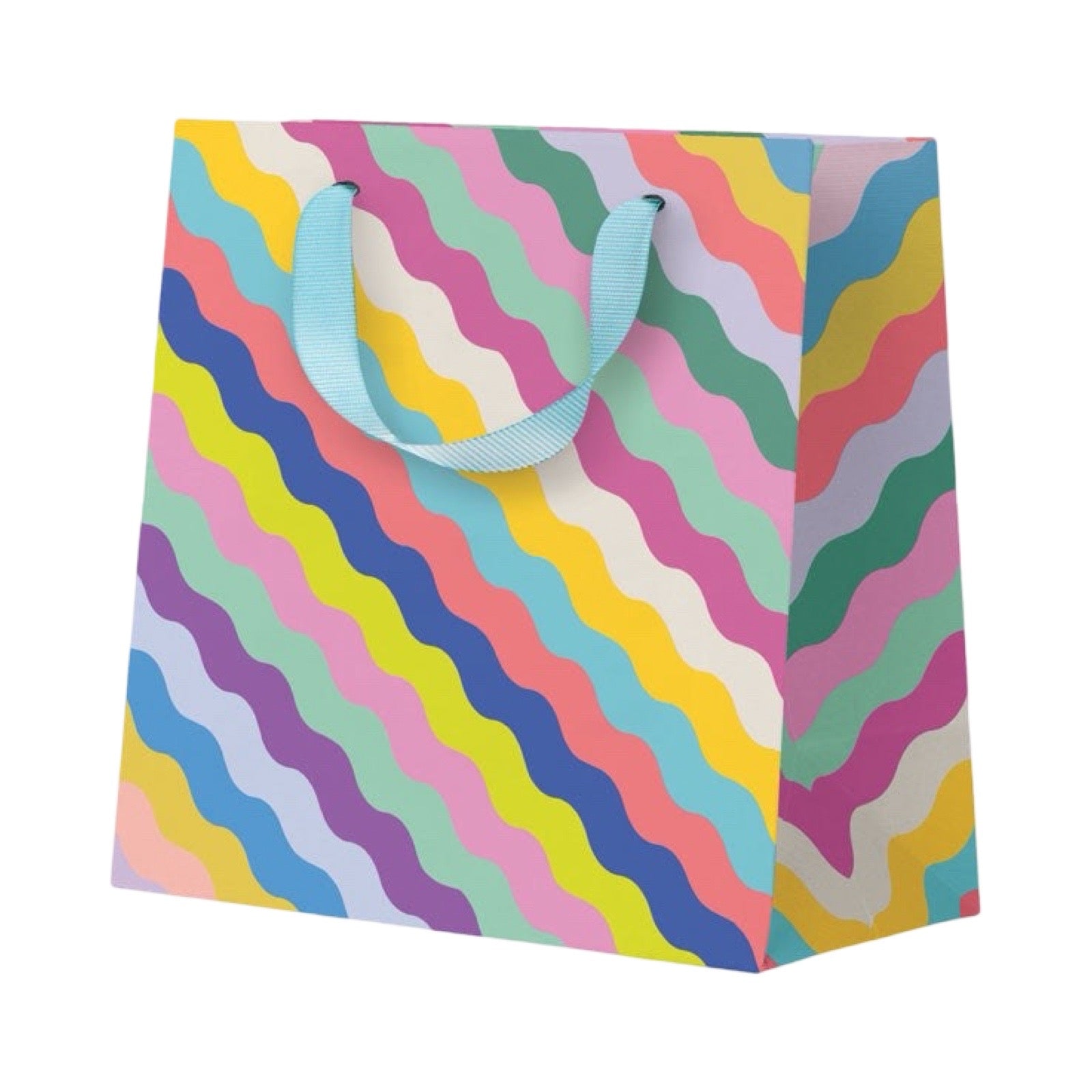 A colorful gift bag with a retro wavy diagonal stripe pattern in pastel shades of pink, yellow, blue, green, and purple, featuring light blue ribbon handles, shown on a plain white background.