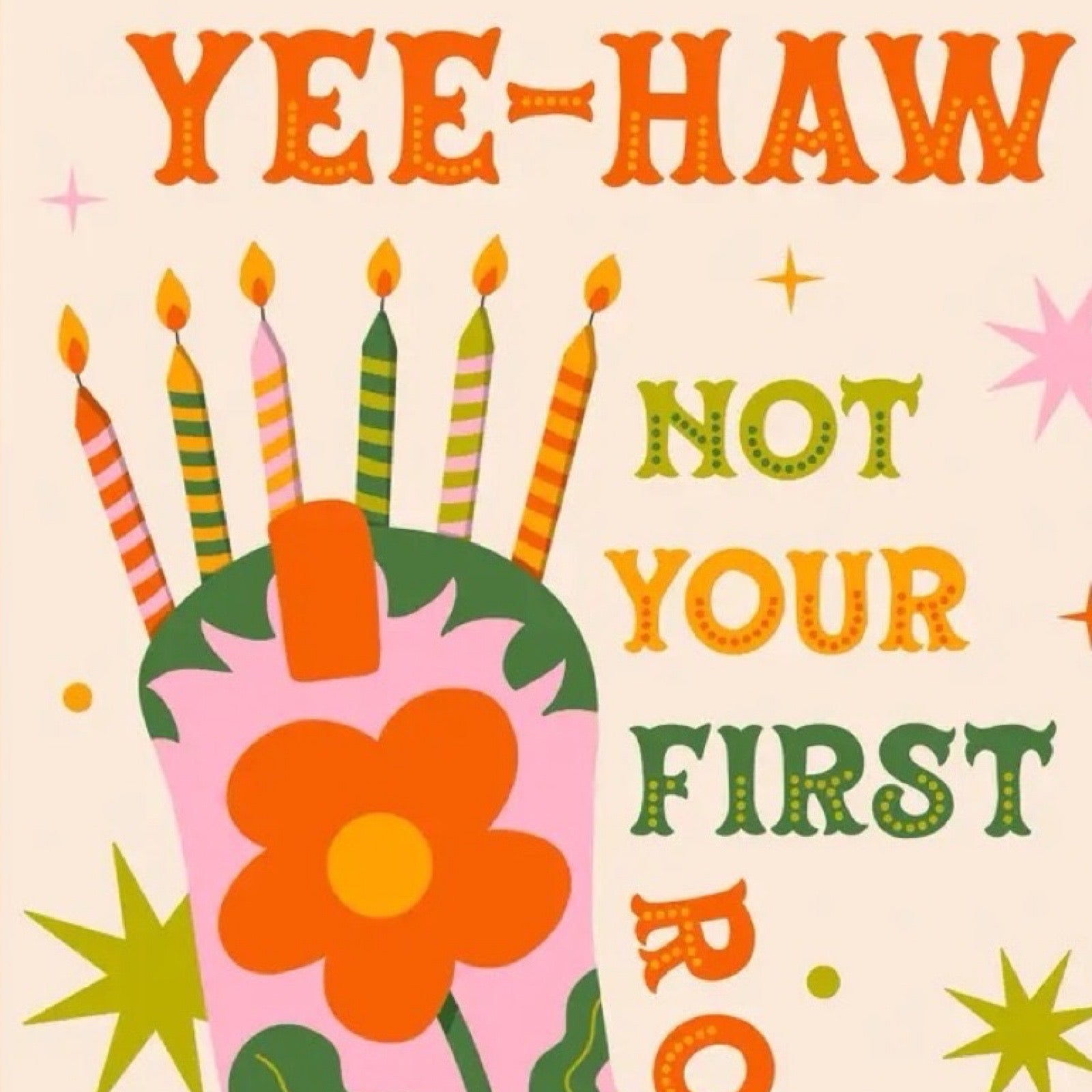 Birthday cake with candles and text 'YEE-HAW NOT YOUR FIRST RODEO' on a beige background.