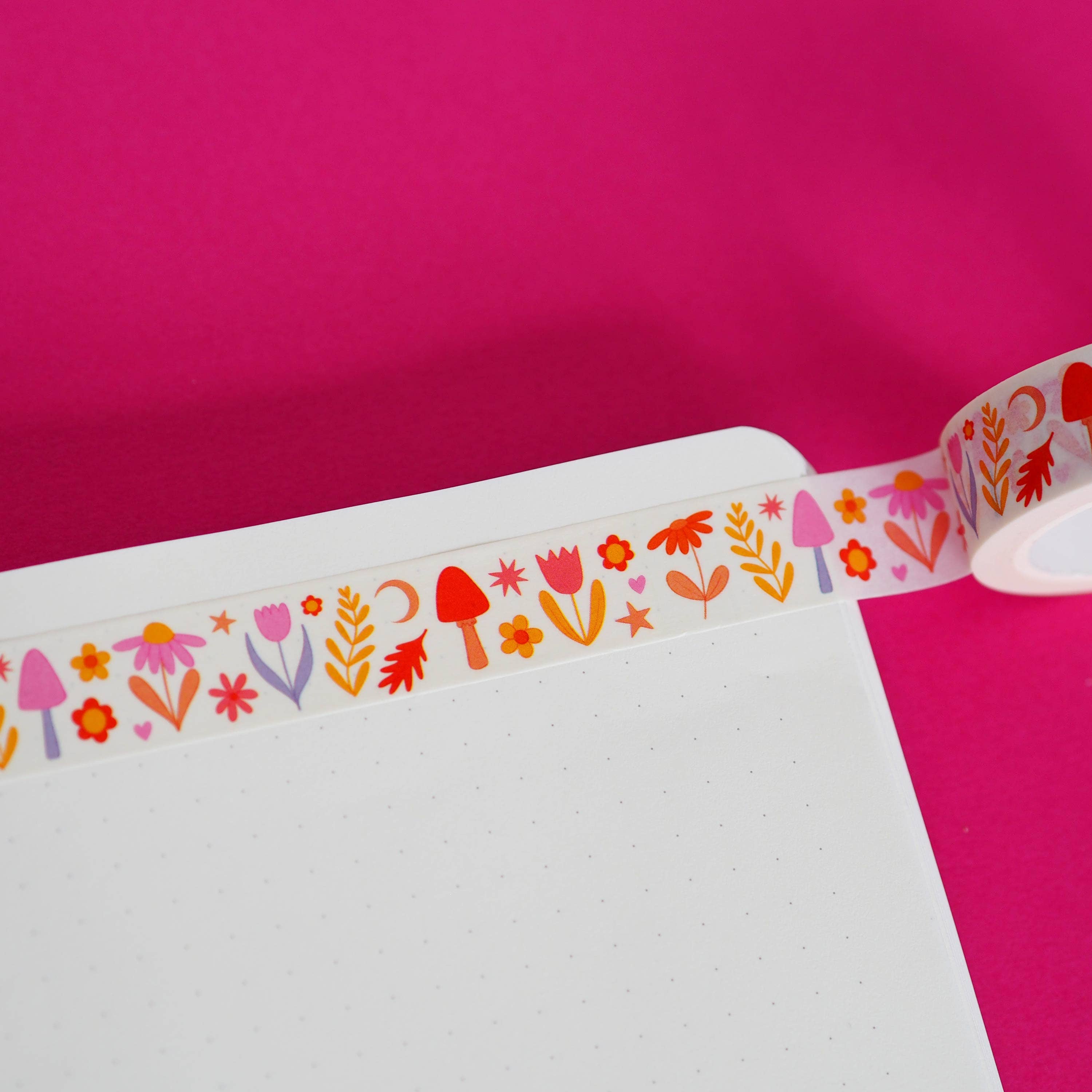 Decorative tape with colourful floral and flower pattern on a pink background.