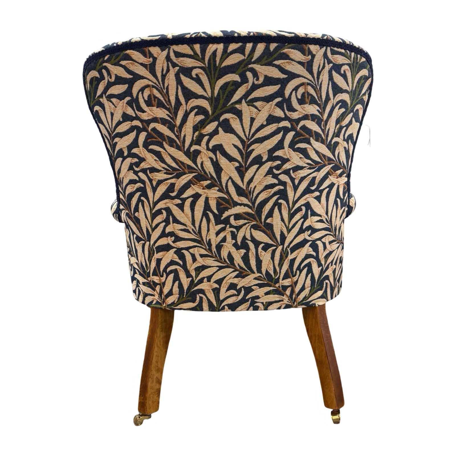 The back of a hand-crafted occasional armchair in blue and cream William Morris Willow Bough tapestry style fabric.