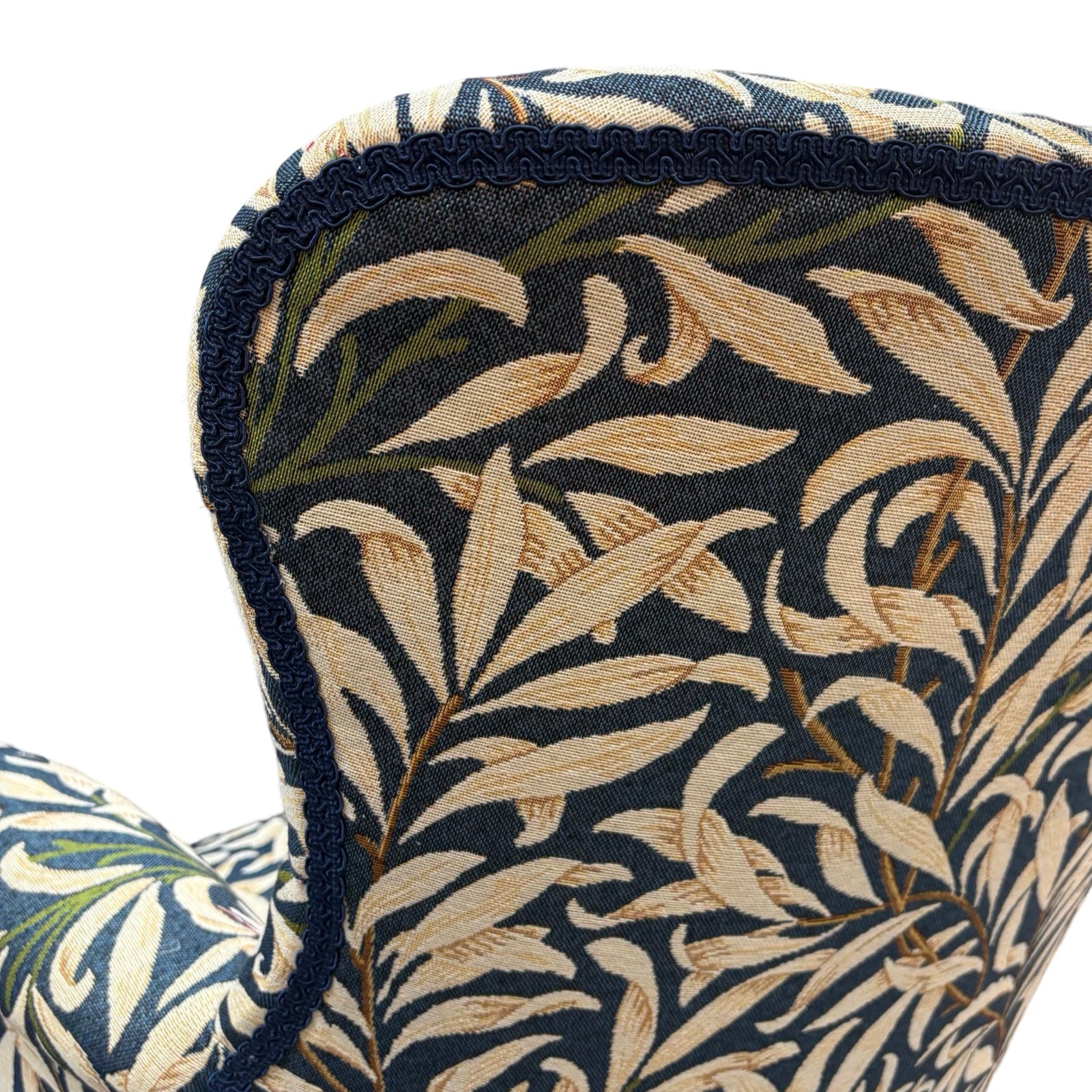The back binding detail on a hand-crafted occasional armchair in blue and cream William Morris Willow Bough tapestry style fabric.