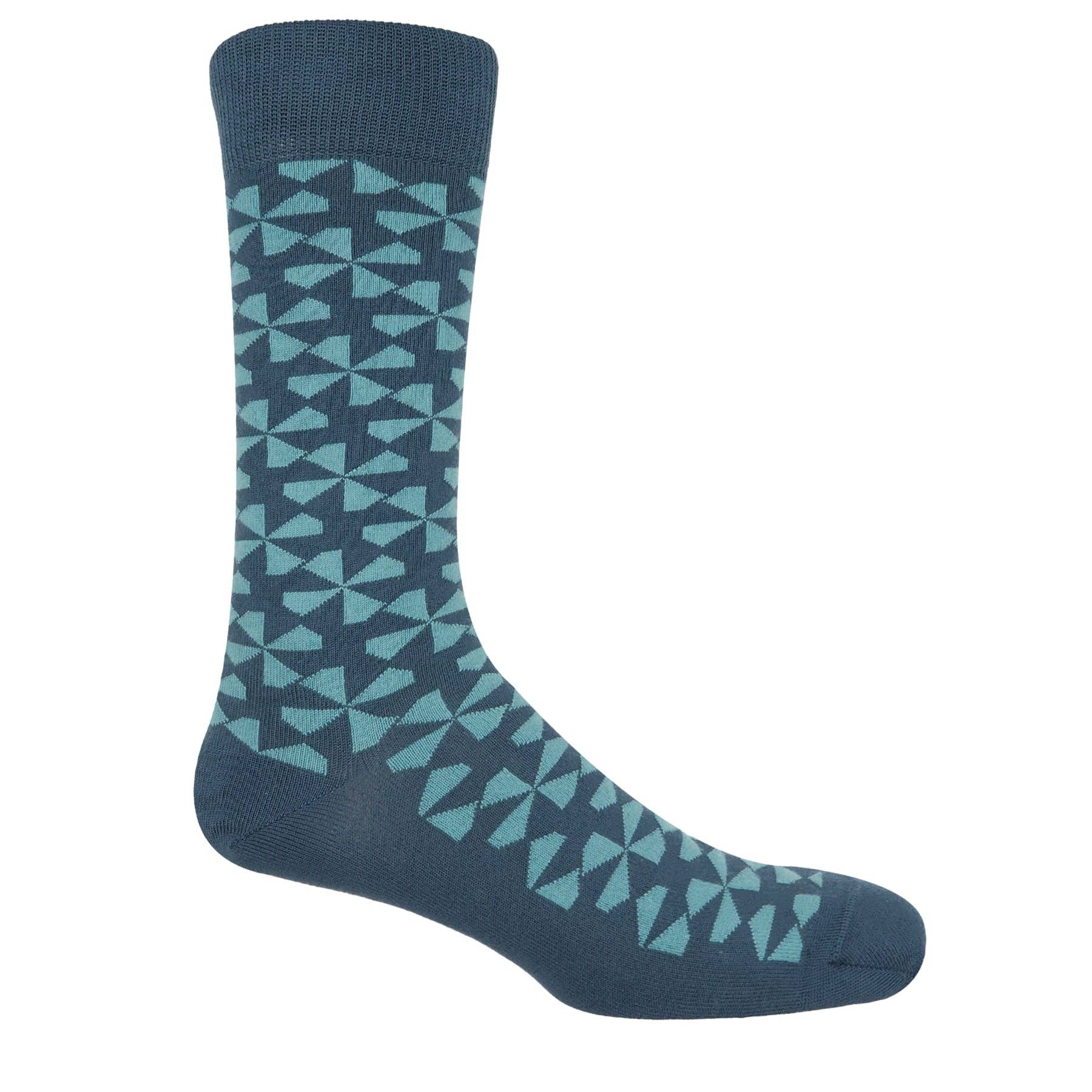 A single crew sock with a geometric pattern of light teal triangles on a dark blue background, shown against a plain white background.