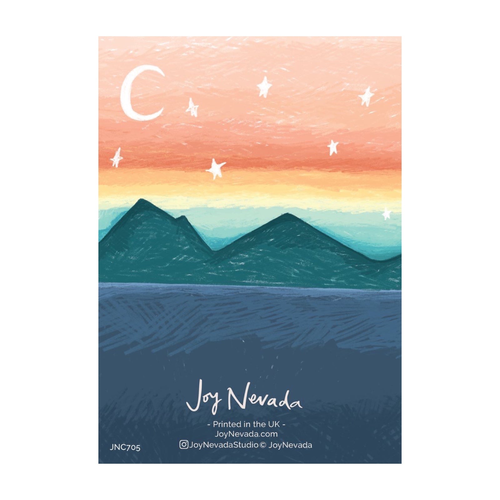 The back of a greetings card with a mountain range under an orange sky.