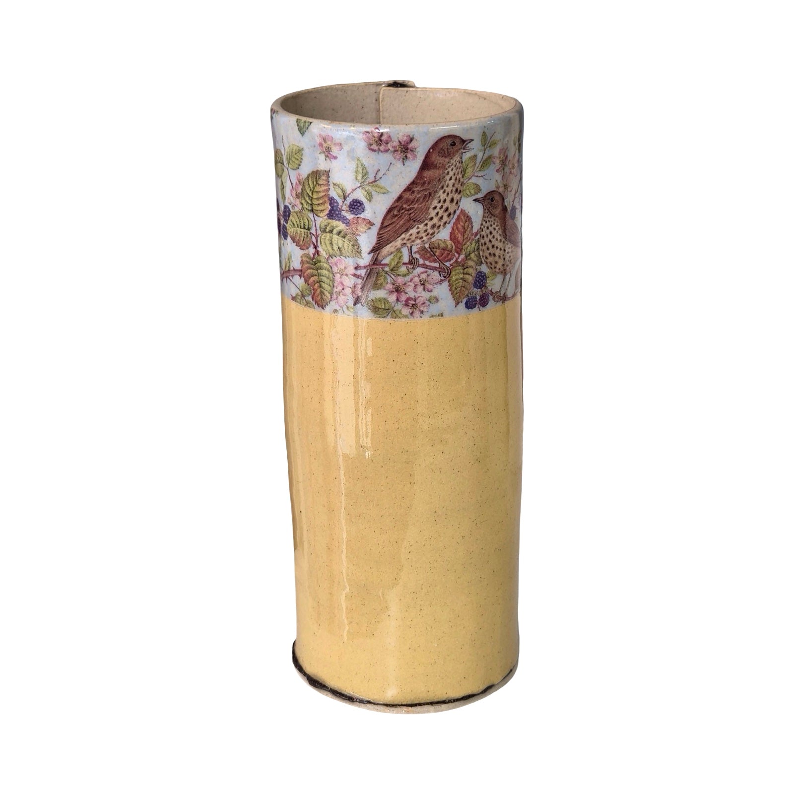 Yellow vase with floral and bird design at the top on a white background.