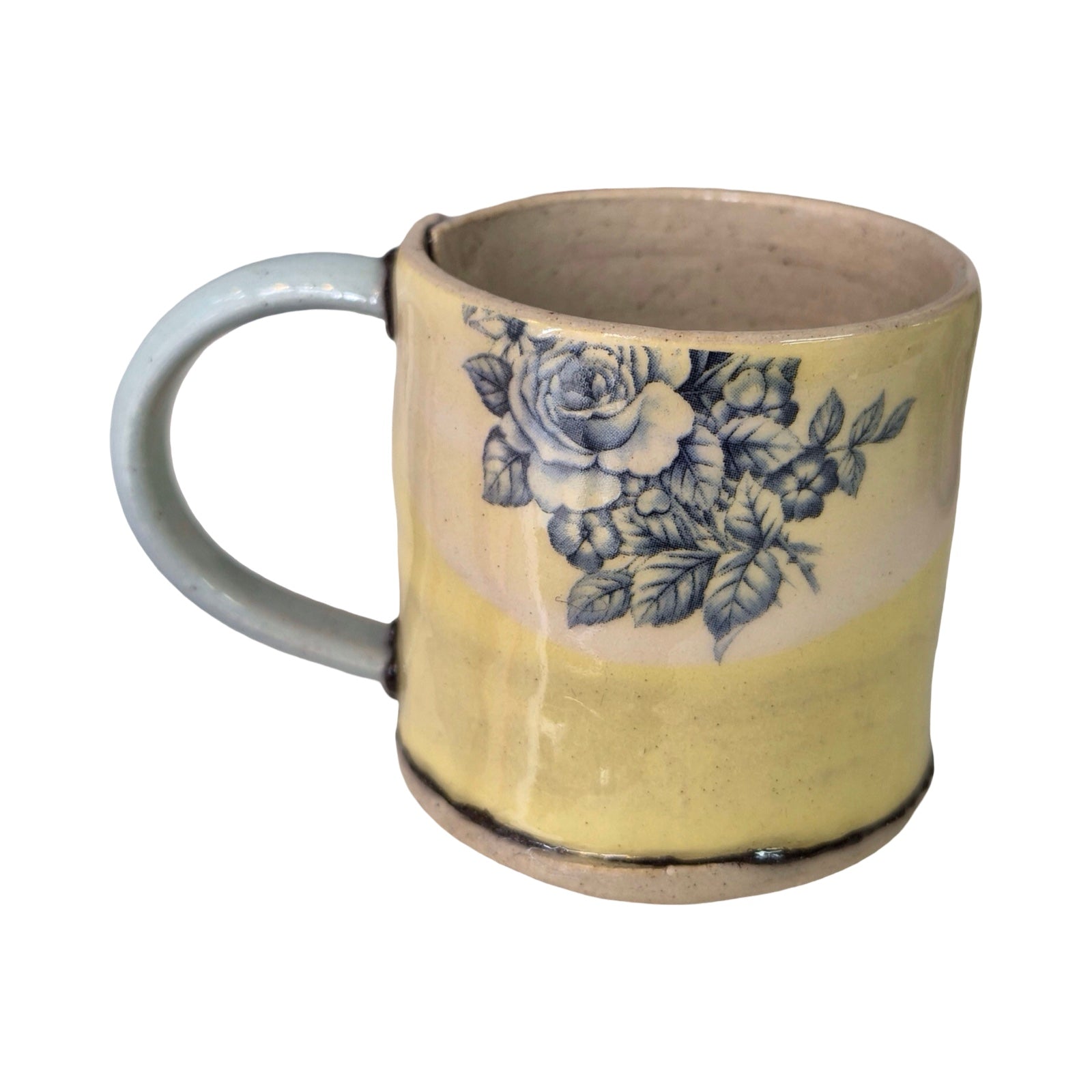 Ceramic mug with floral design on a white background.