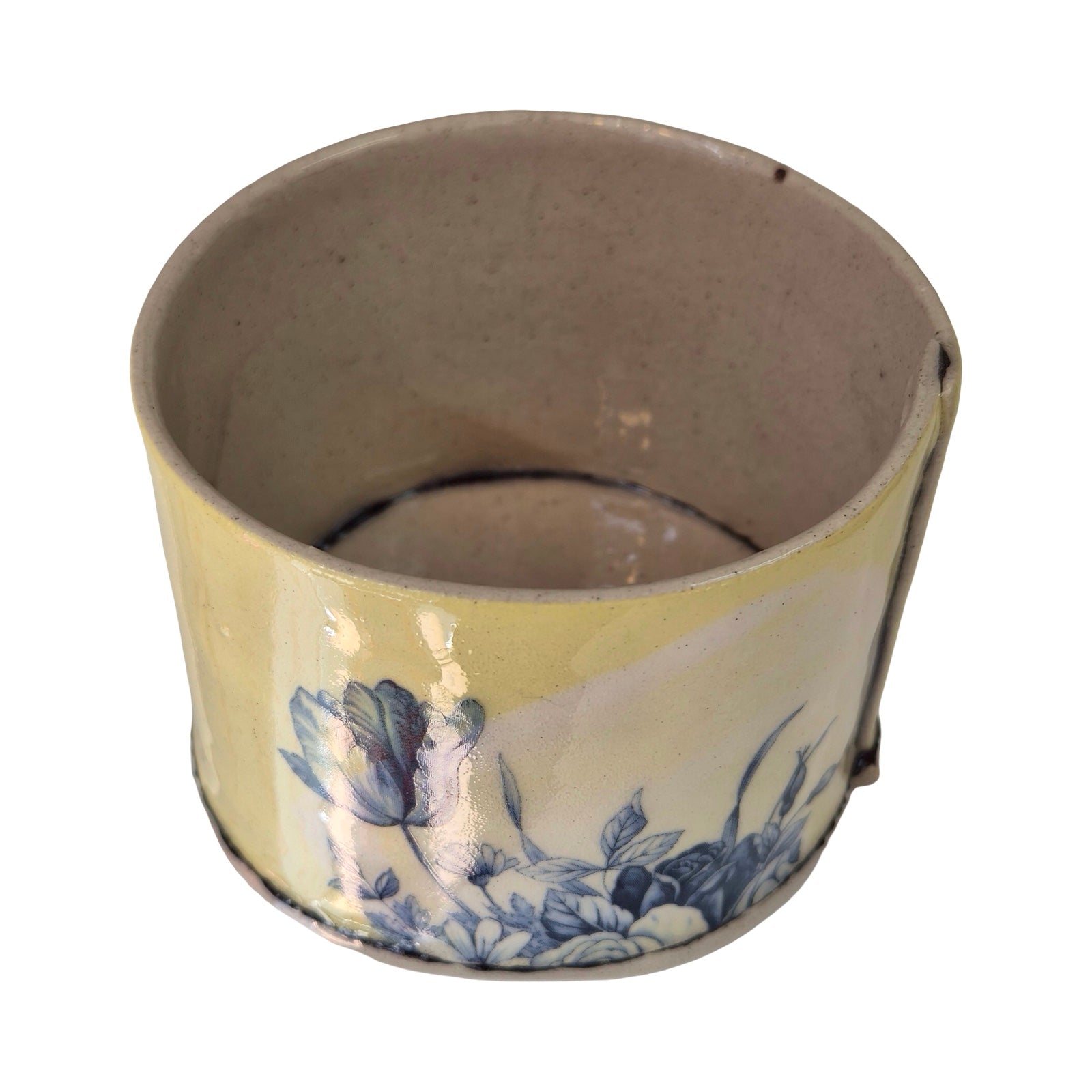 Ceramic planter with blue floral design on a white background.