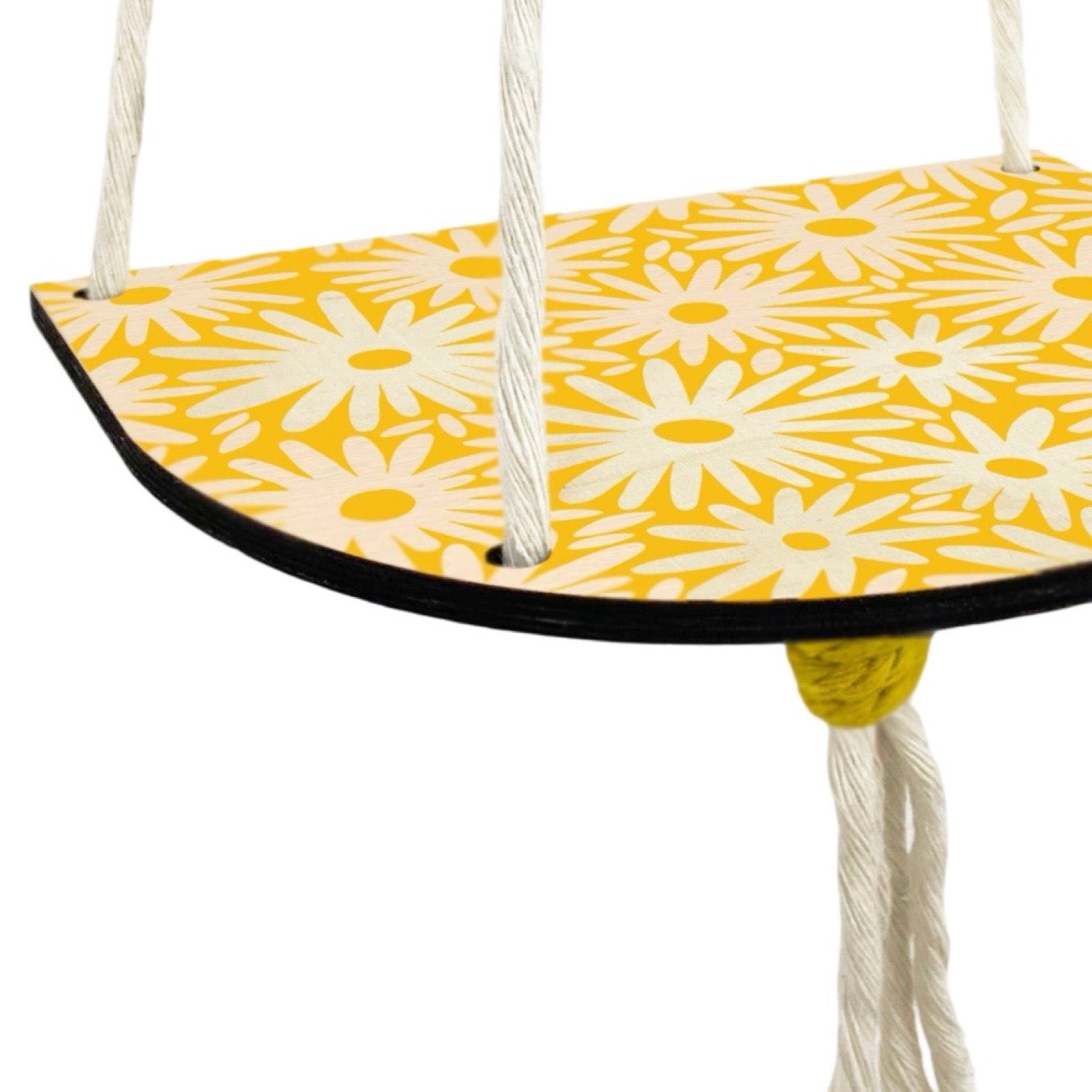 Yellow swing seat with white floral pattern on a white background.