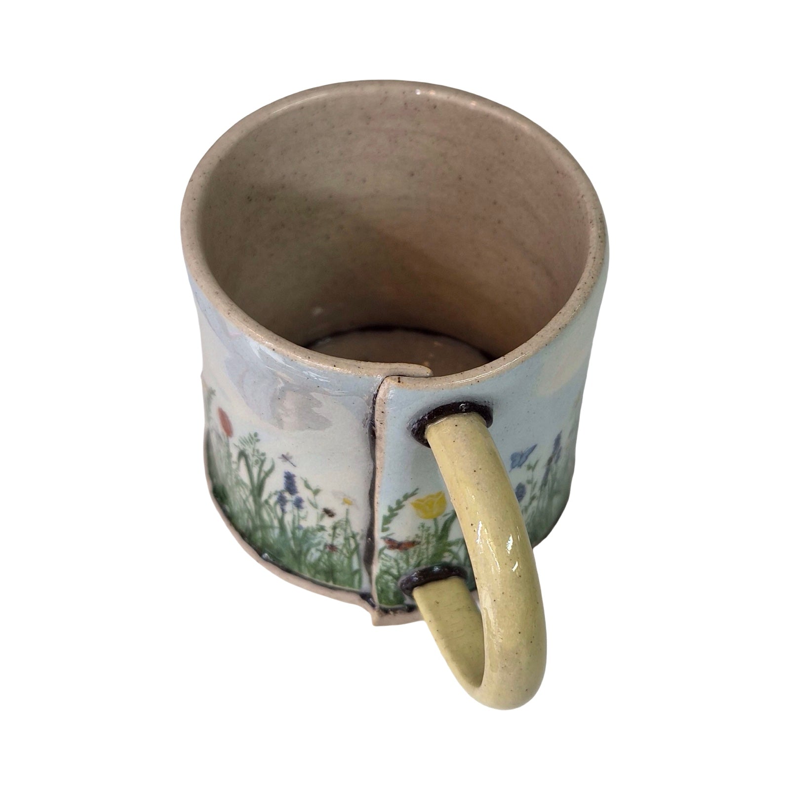 Ceramic mug with floral design on a white background.