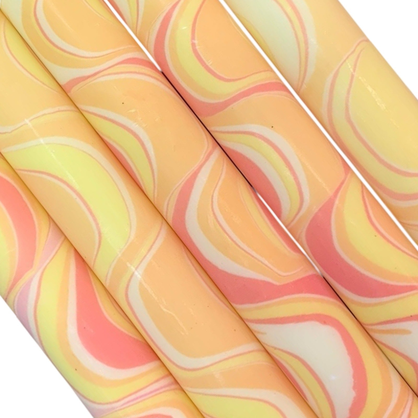 A row of 5 handmade dinner candles marbled in shades of yellow.