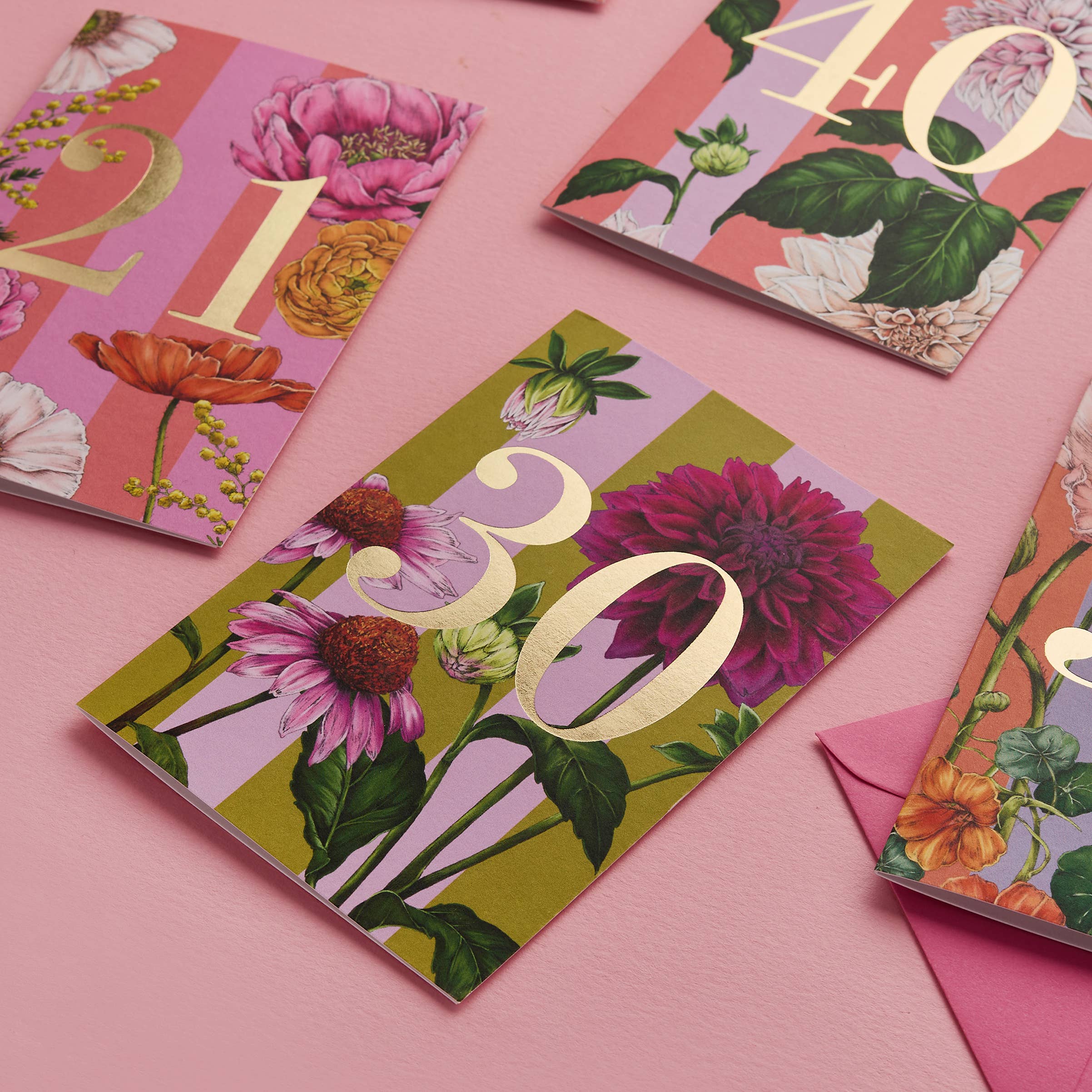 Floral-themed greeting cards with numbers on a pink background.