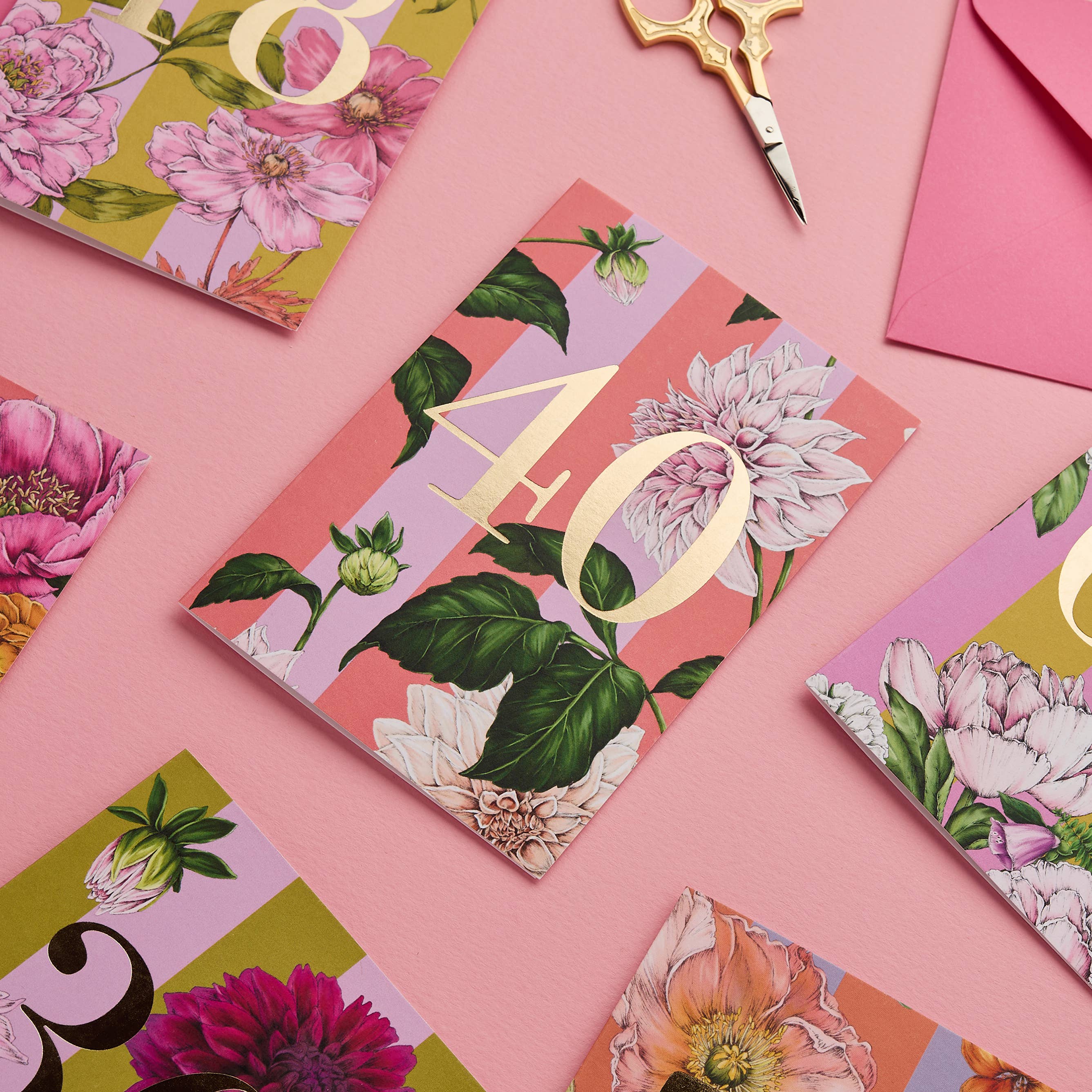 Floral card with number 40 on a pink background with scissors and envelopes.