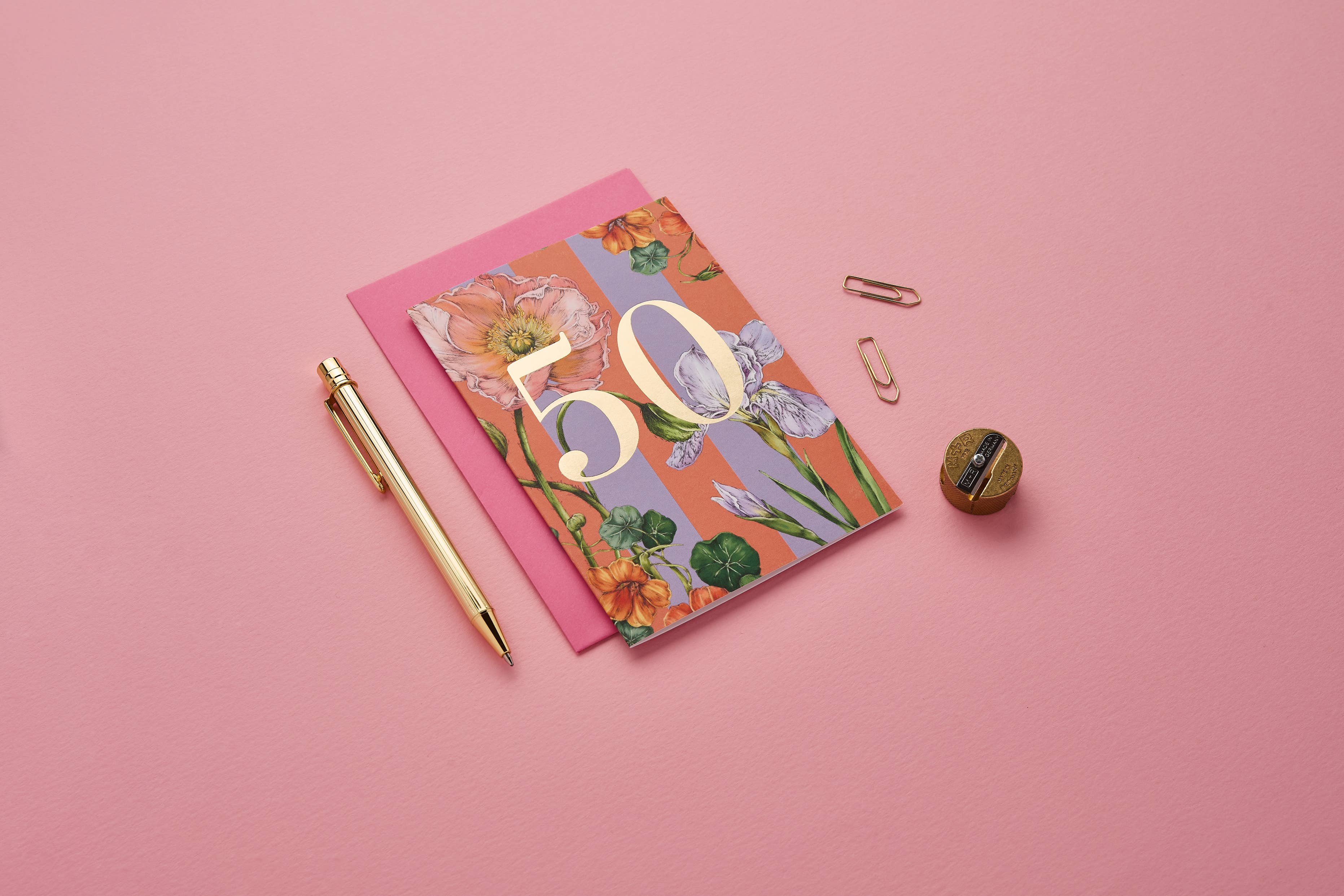 Floral notebook with '50' on a pink background.