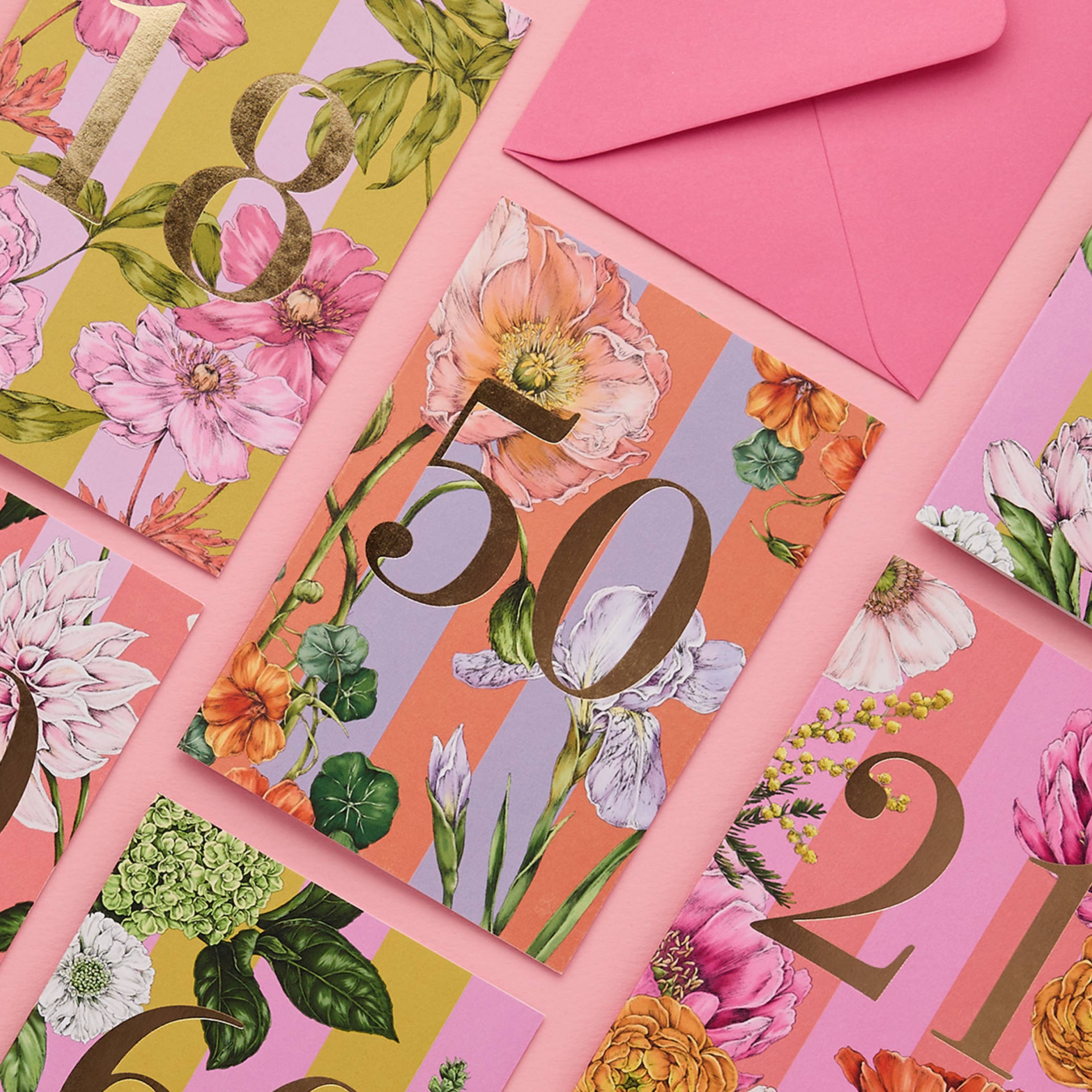 Floral-themed cards with decorative numbers and a pink envelope.