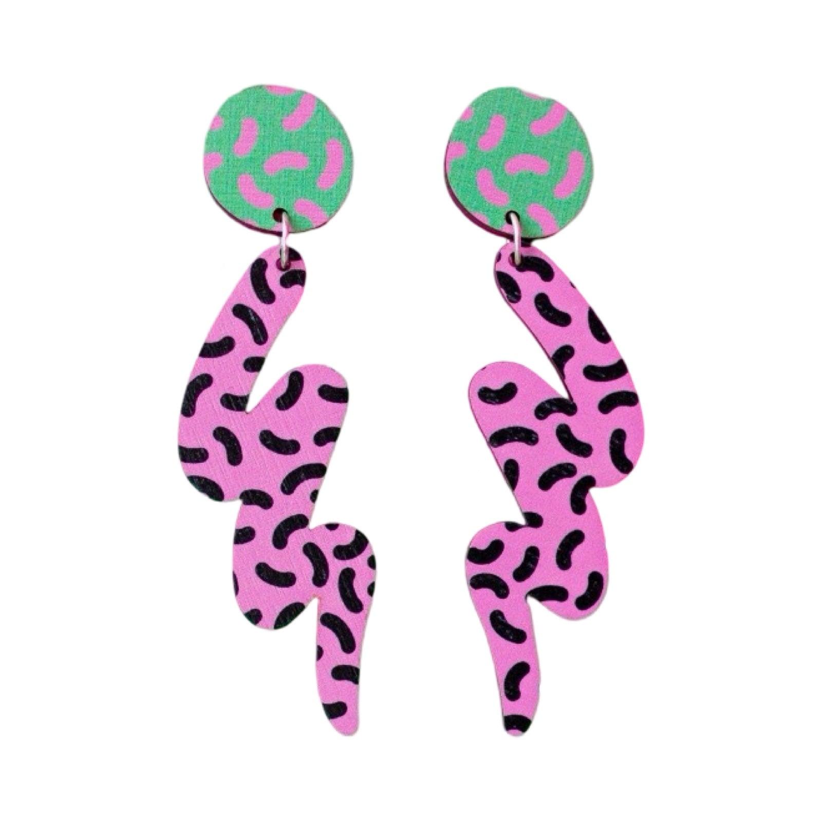 These wooden earrings feature green circular studs with pink dashes with a large pink and black dashed squiggle hanging underneath.