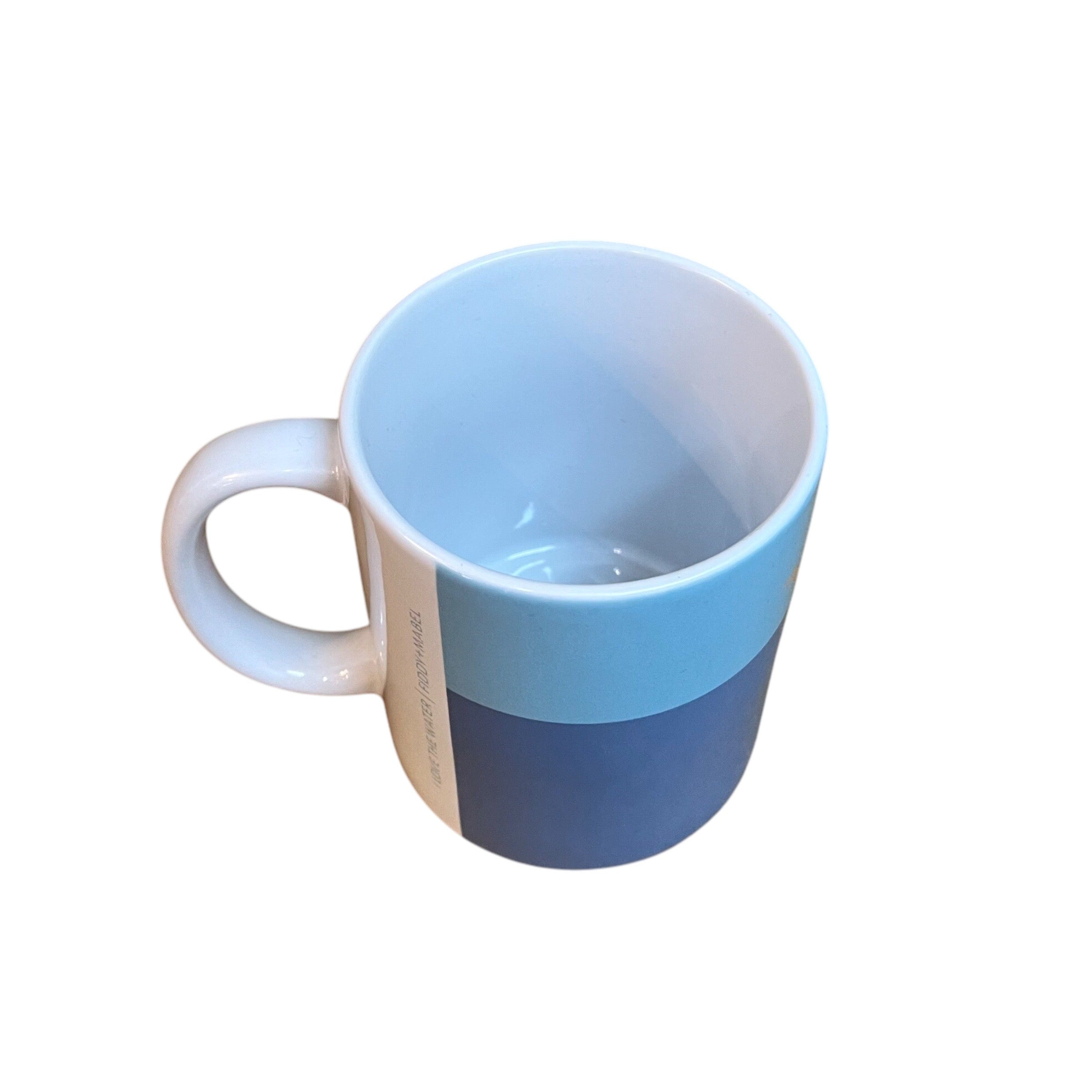 Mug featuring a female wild swimmer wearing a black swimsuit standing knee-deep in the water with her arms stretched out above her. Perfect for fans of wild swimming. This ceramic mug holds 10oz and is dishwasher safe.