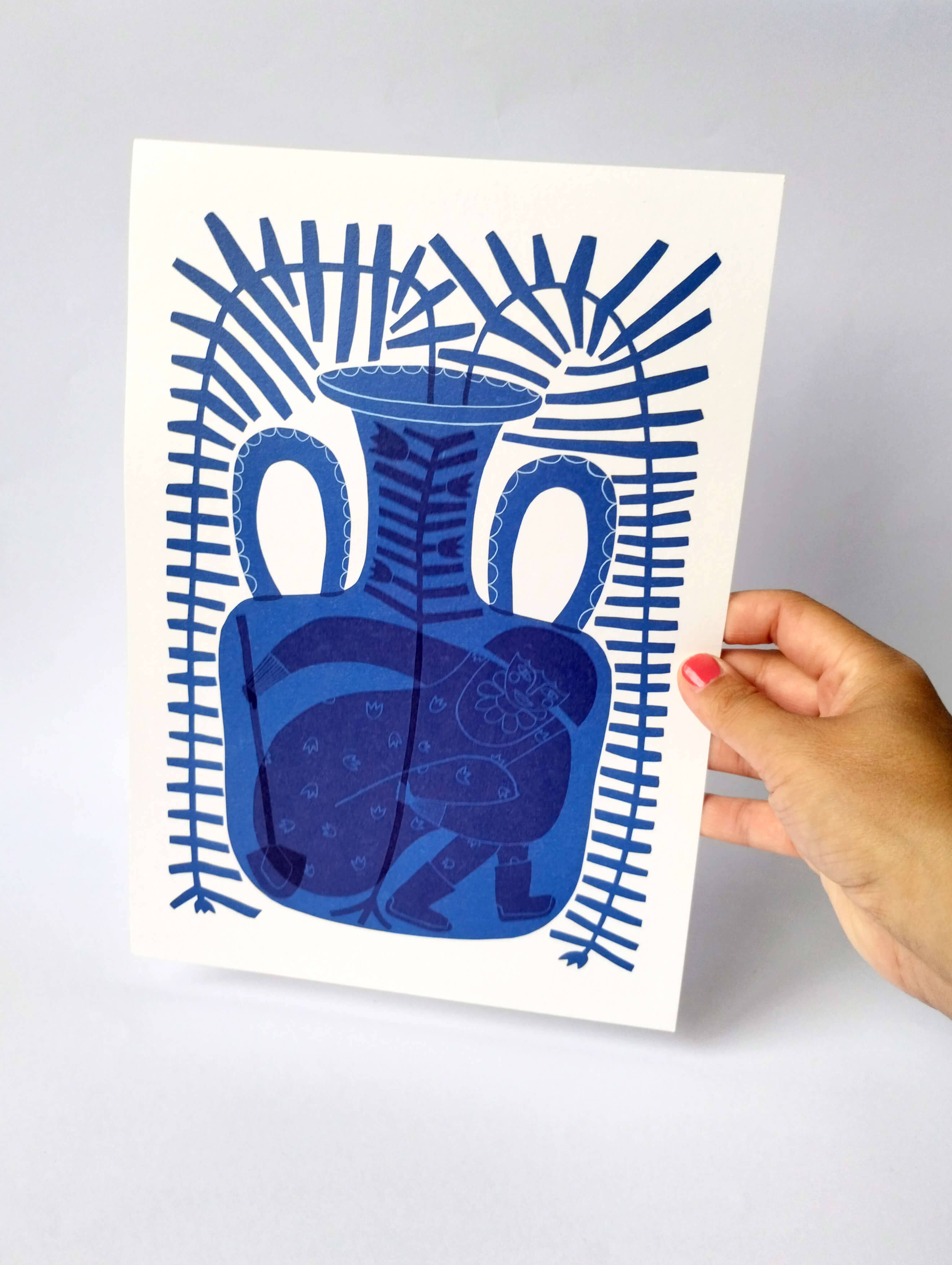 Hand holding a blue vase illustration on a white card against a grey background.