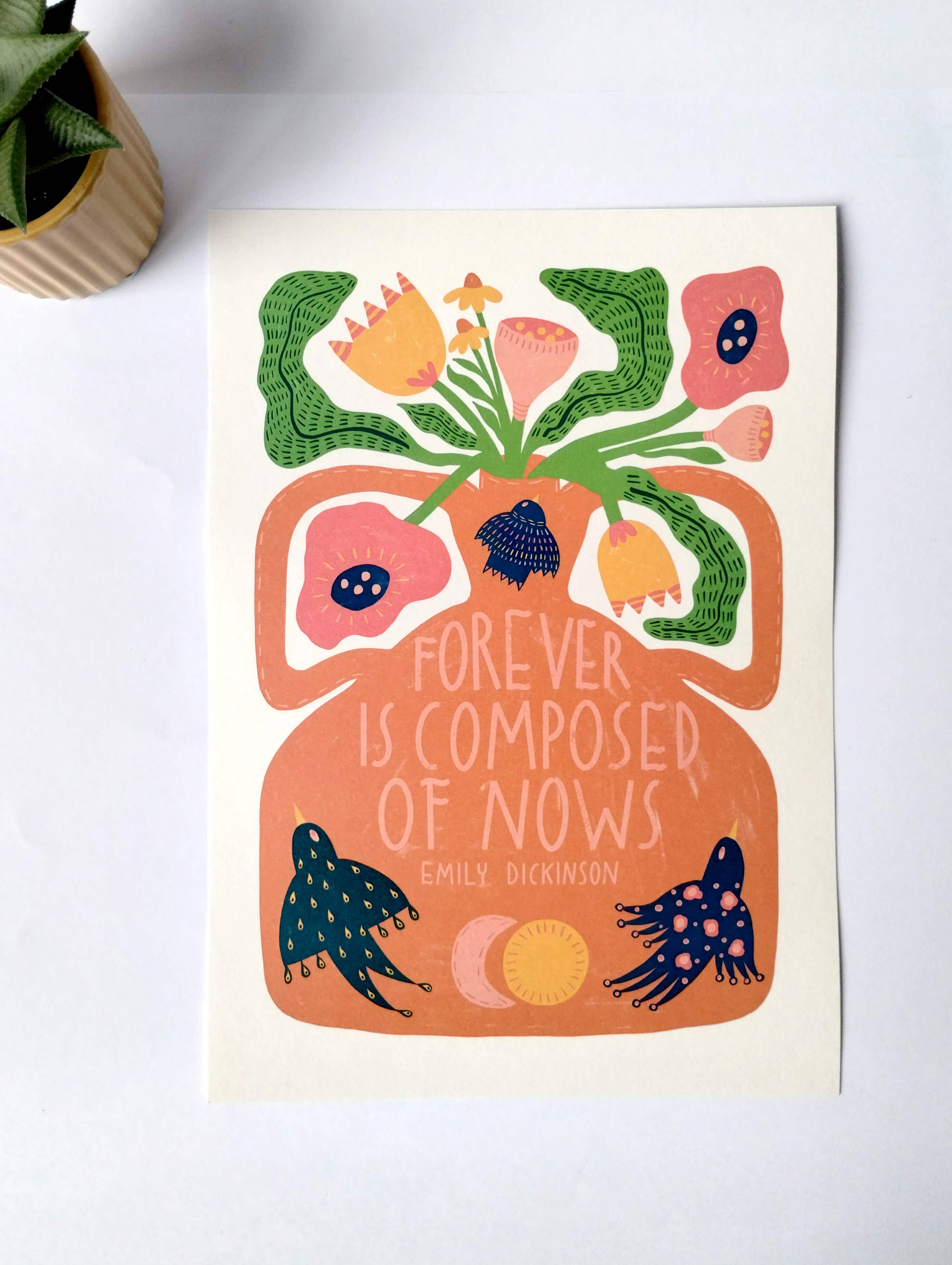 Decorative print with floral design and Emily Dickinson quote on a white surface.