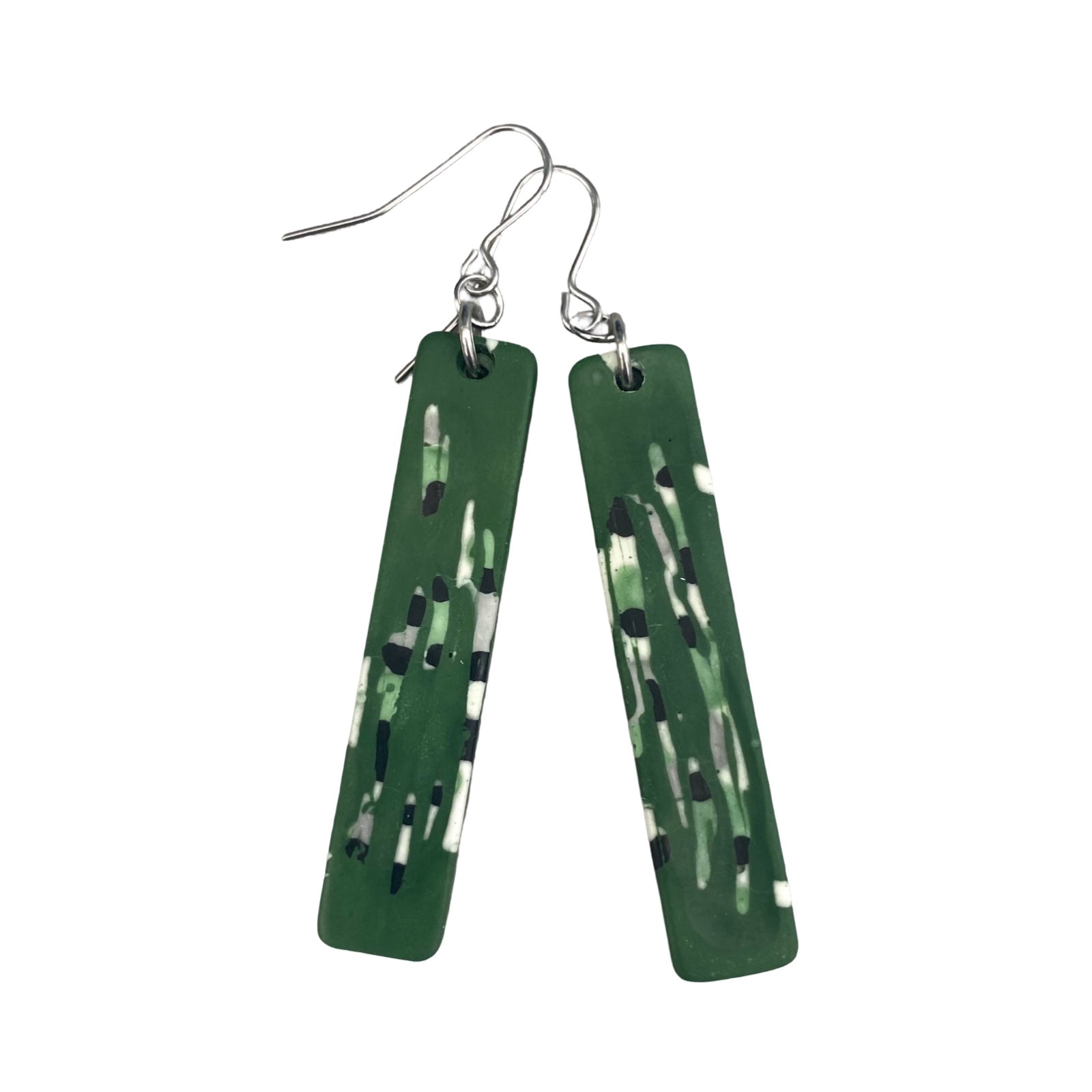 A pair of long rectangular earrings in green with an black, white and grey abstract design and stainless steel earring posts.