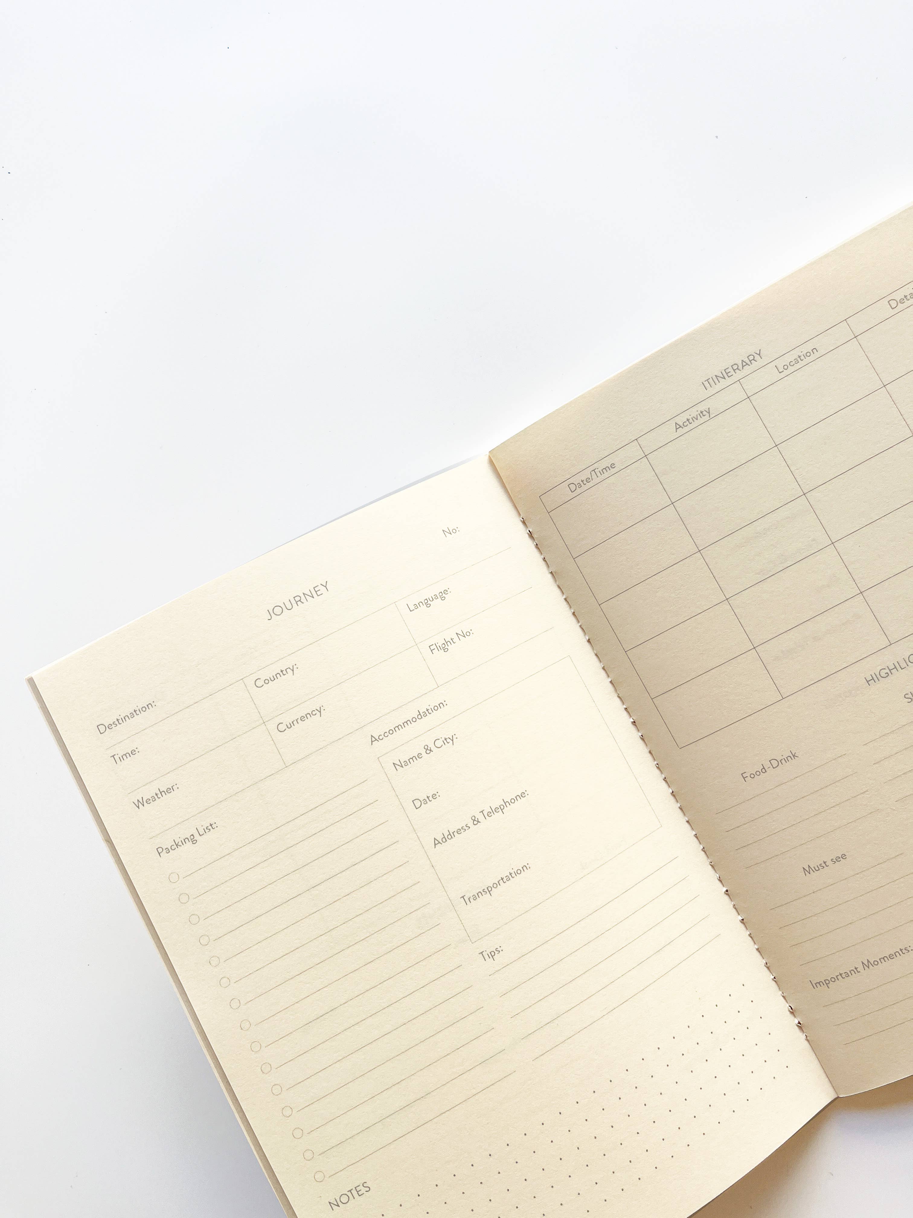 Open notebook with grid and text pages on a white background.