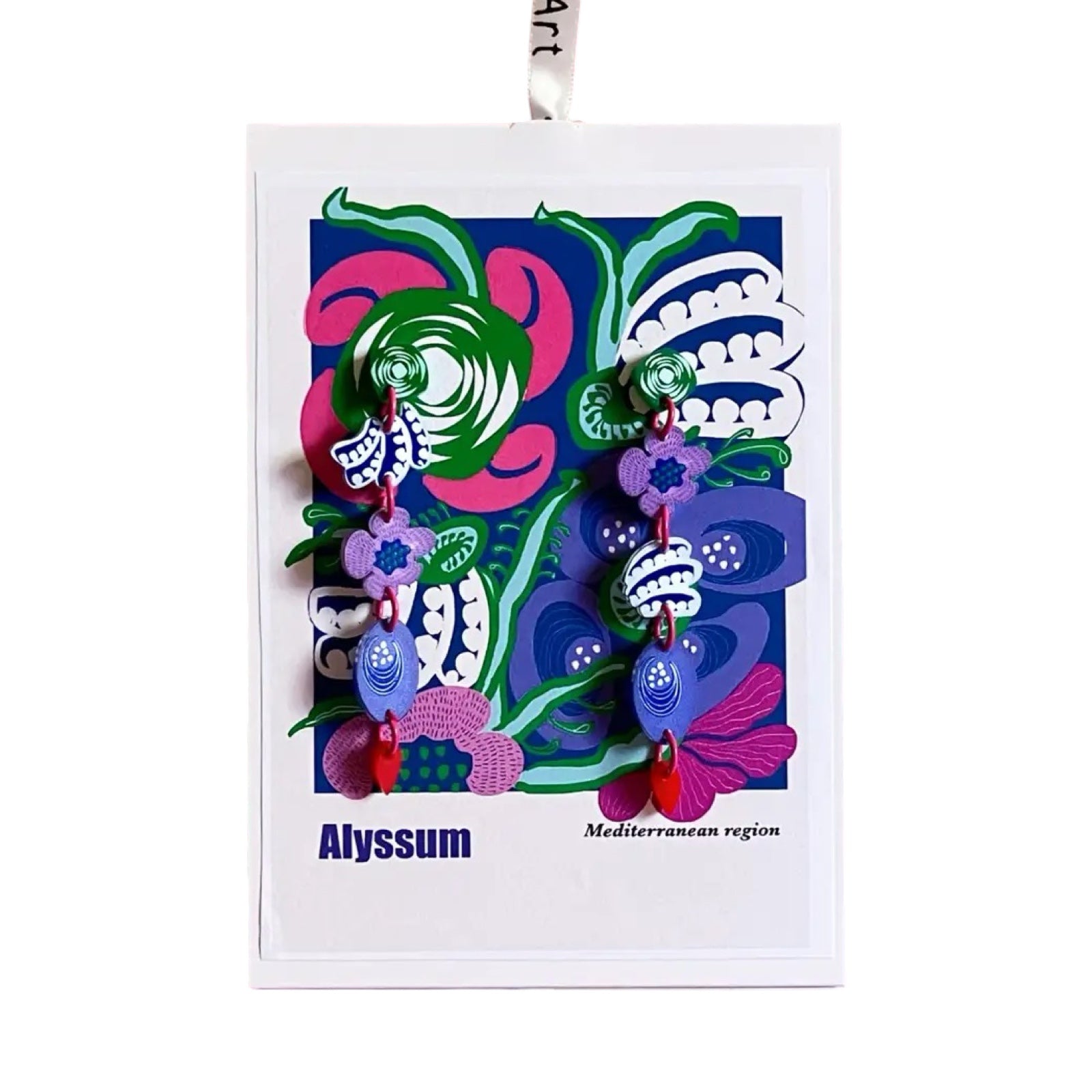 A pair of acrylic dangle earrings with green squares, pink flowers, navy and white leaves and blue leaves on a matching backing card.
