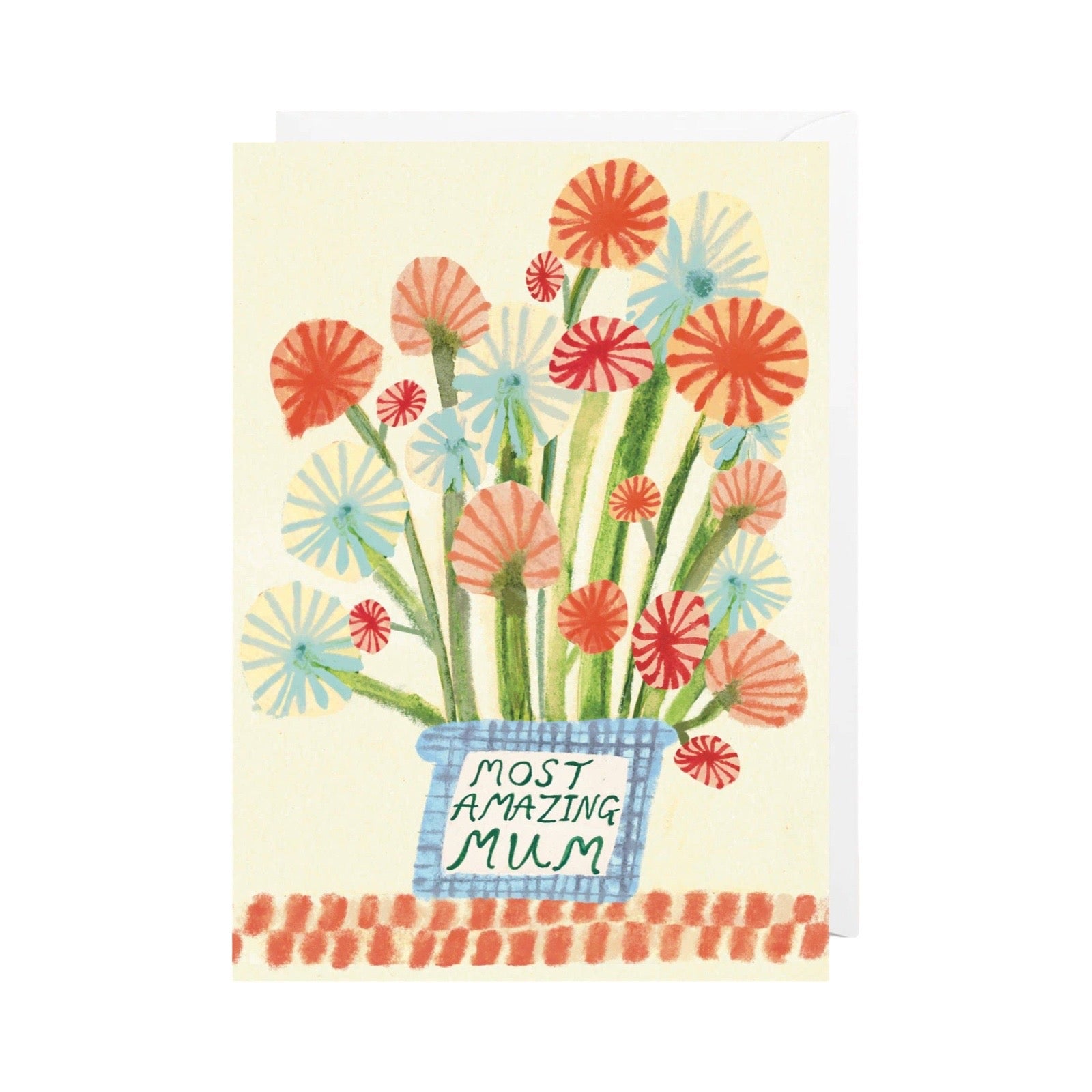 A greeting card featuring a watercolour-style illustration of colourful flowers in a blue basket with the text 'MOST AMAZING MUM' on a cream background.