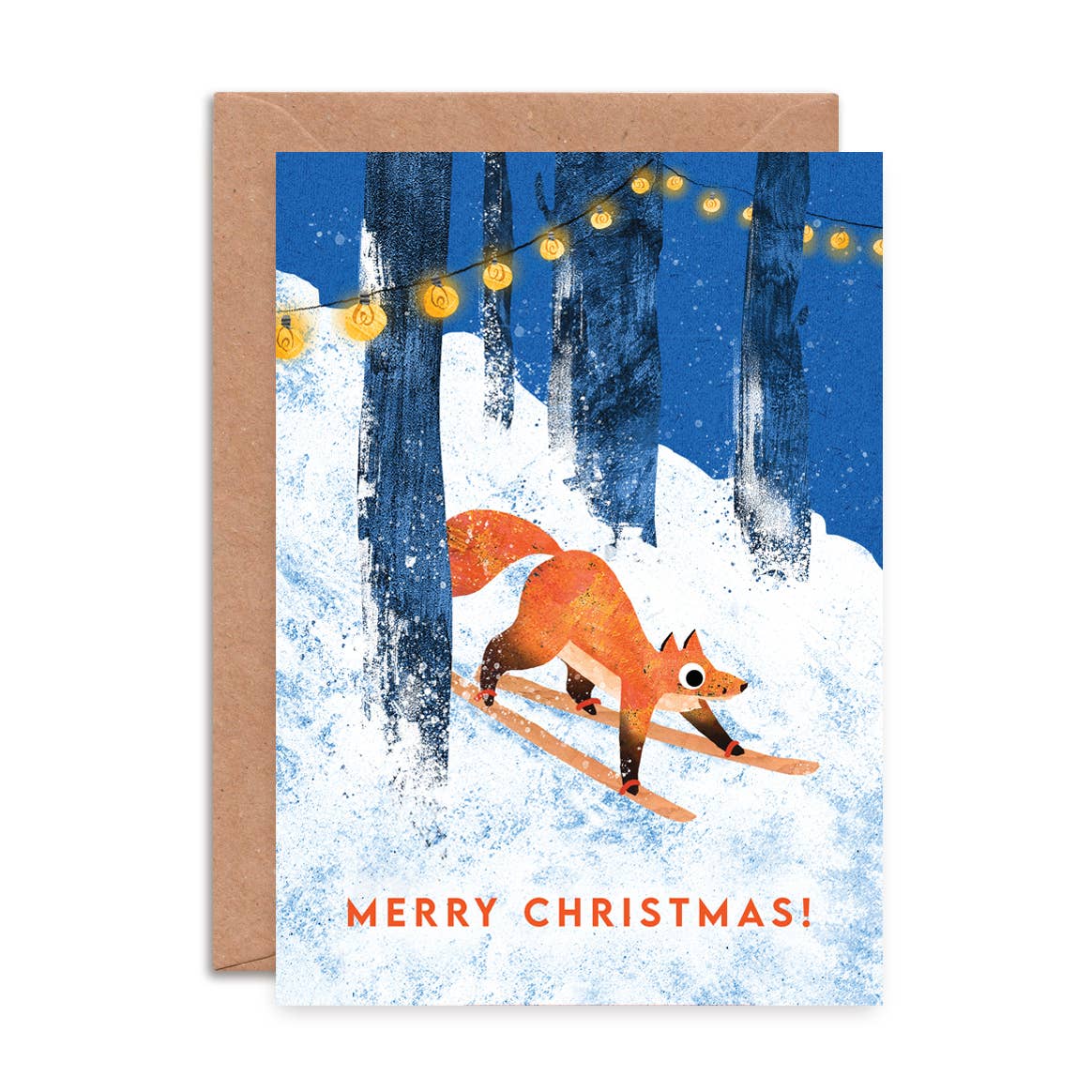 A Christmas greeting card with a kraft envelope, featuring an illustration of an orange fox skiing through the snow under string lights, with 'MERRY CHRISTMAS!' printed at the bottom.